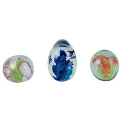 Scandinavian glass artist. Three paperweights in art glass. Flower motifs.