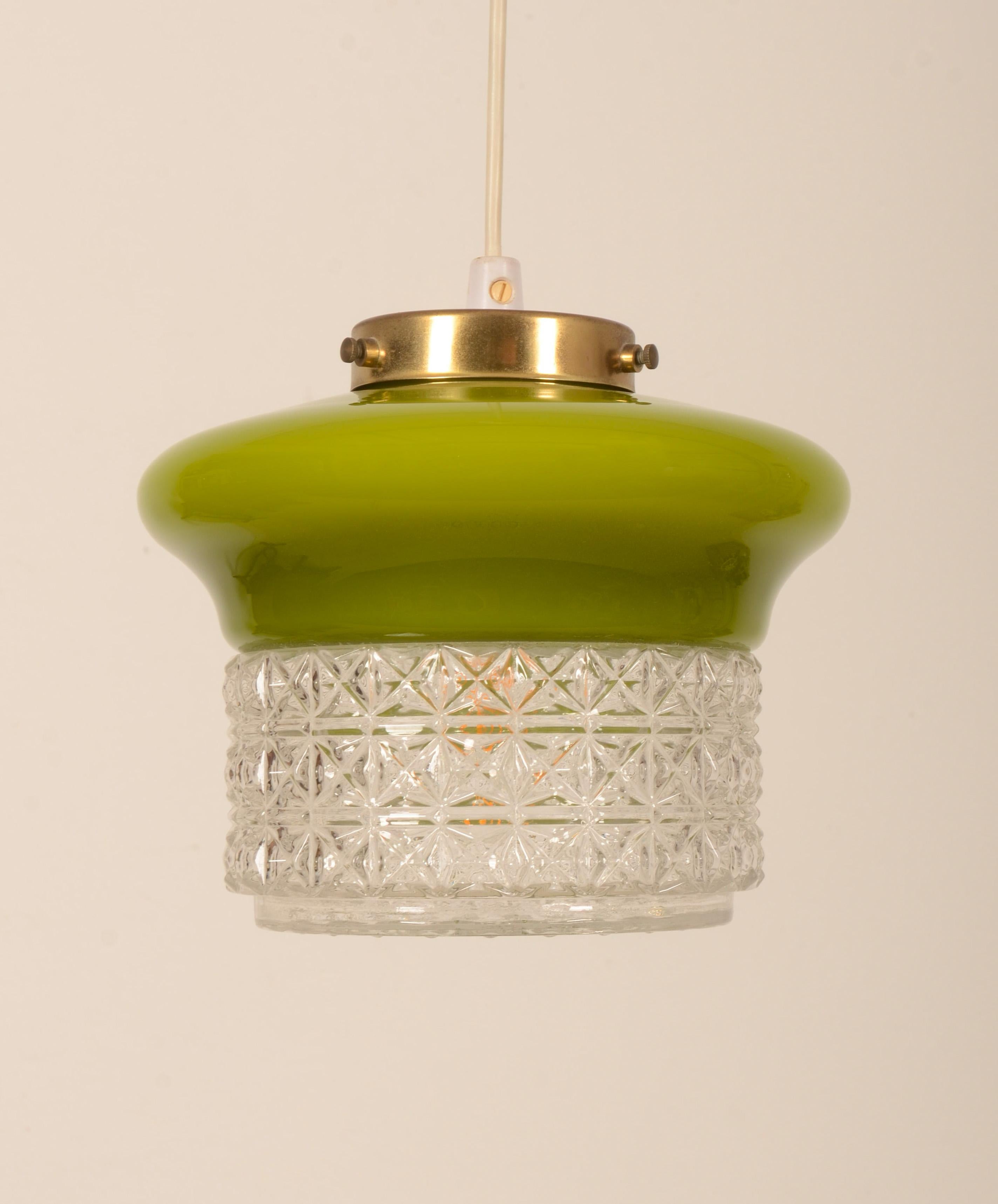Glass pendant lamp with glass shade green on top and clear structured glass below. Fitted with one E27 socket. Made in 1970s in Sweden by ÖIA Belysning  Another one with an orange top is in my other listing available, see the last picture