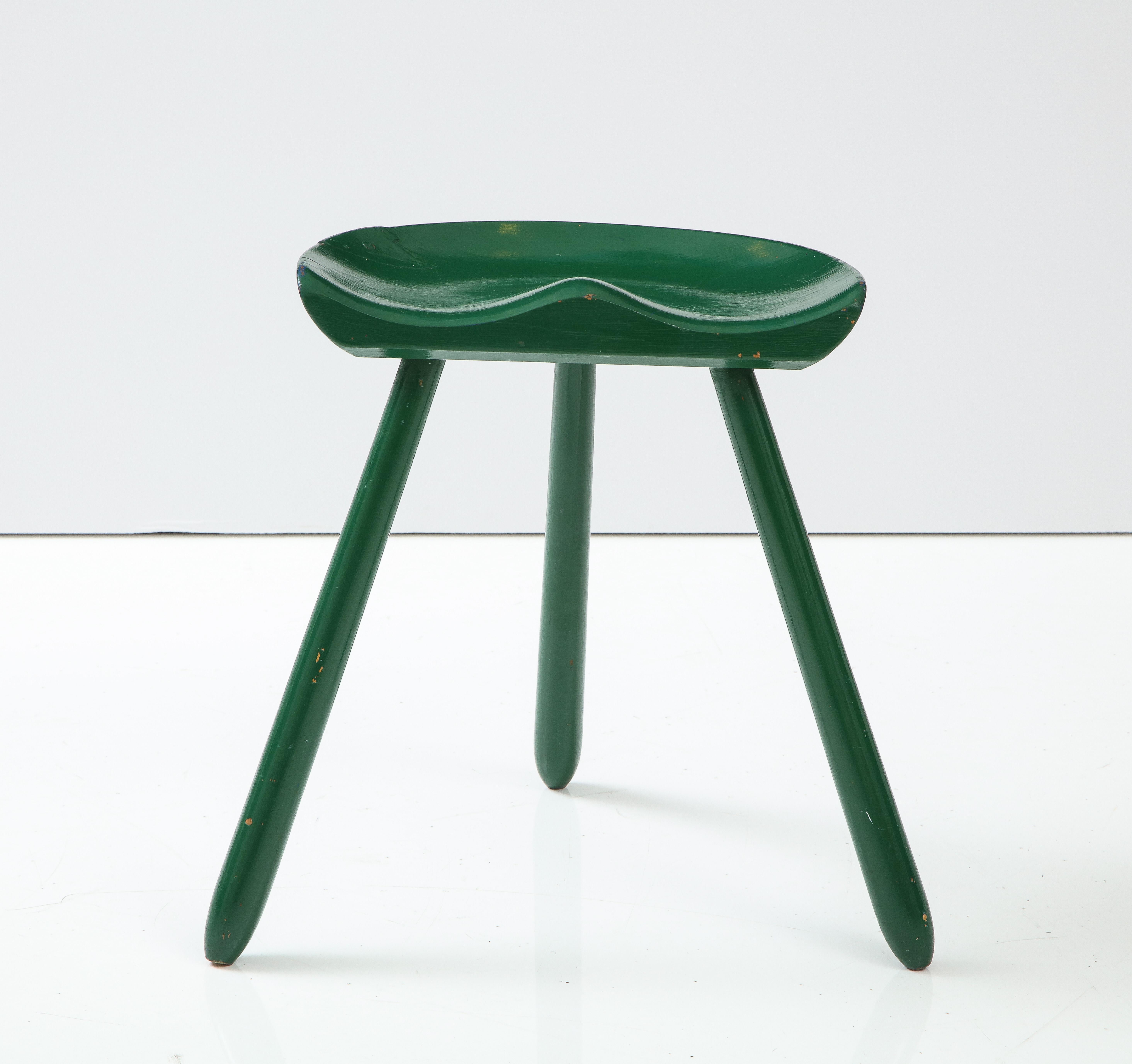 A Swedish or Danish painted wood tractor seat form tripod stool, Circa 1960s.