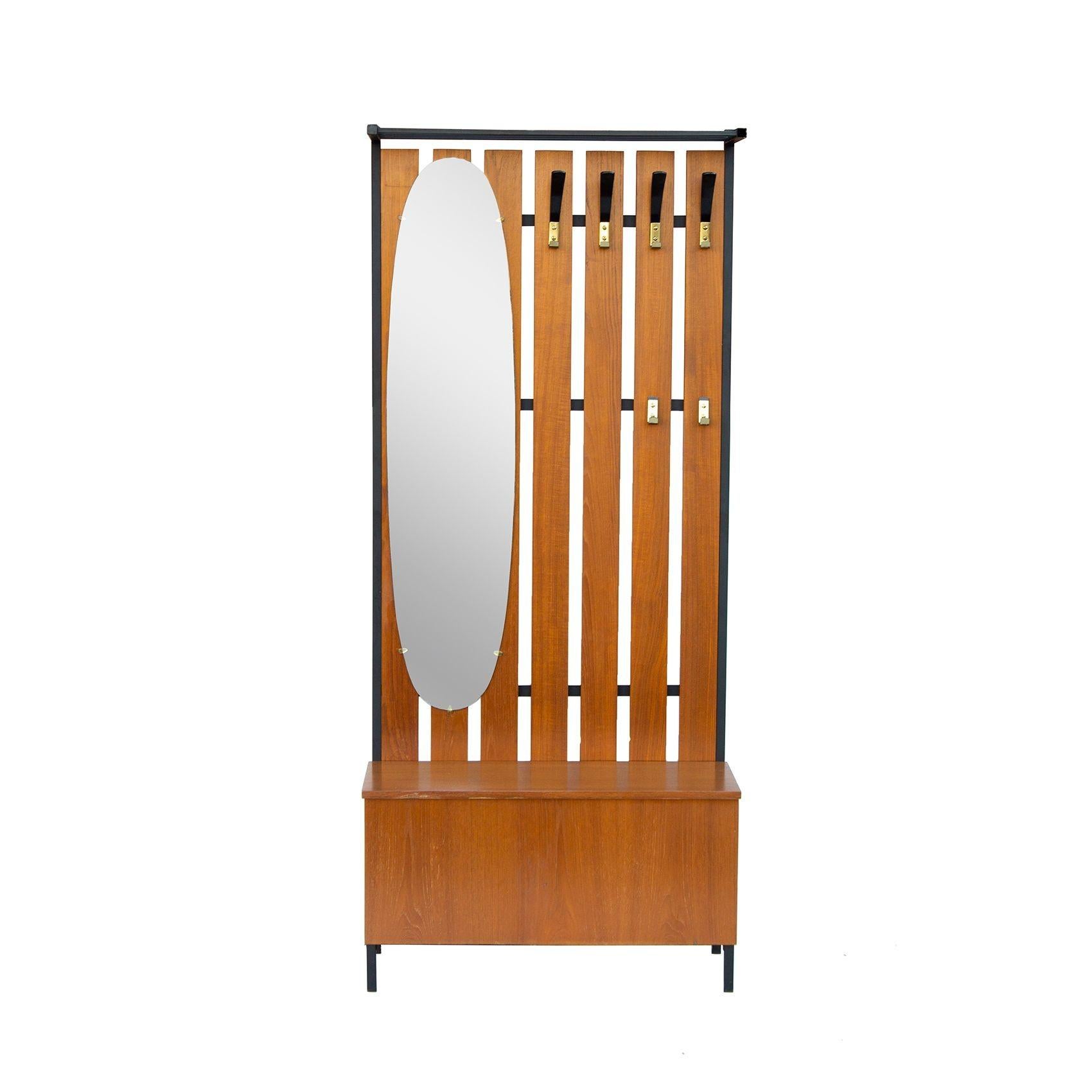 Denmark, 1970s
Scandinavian hall tree in teak with a hat rack above and six hooks- four higher hooks and two lower hooks below. Oval mirror at left. Signed Staalmeubelen M.L.D Munterbilzen.
CONDITION NOTES: The edge banding on the front edge of the