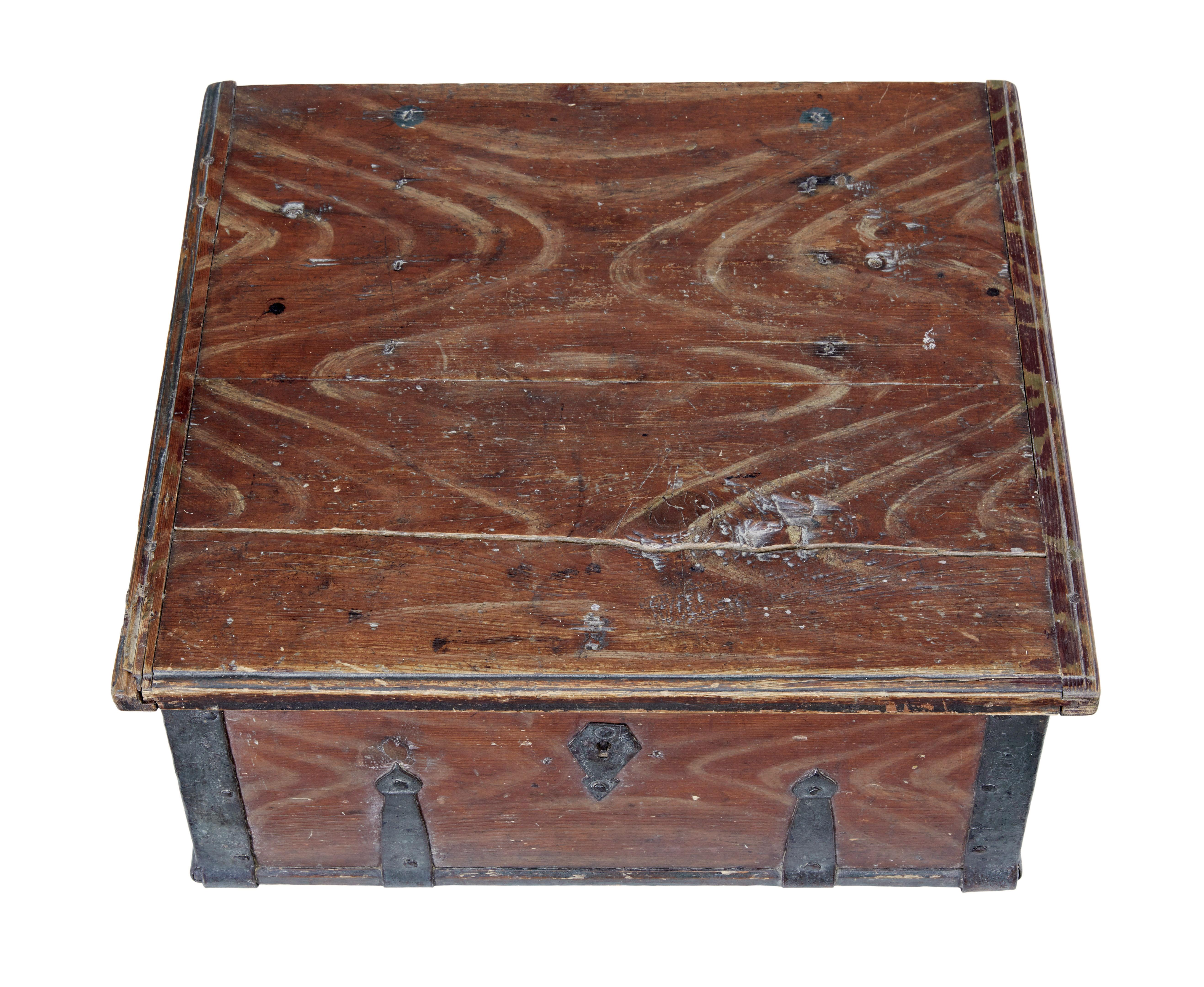 Scandinavian hand painted 19th century pine strong box circa 1840.

Good example of traditional rustic Swedish woodwork.  Painted in a russet red paint with hand painted cream drags.  Original iron strap work and hinges, also the original lock,