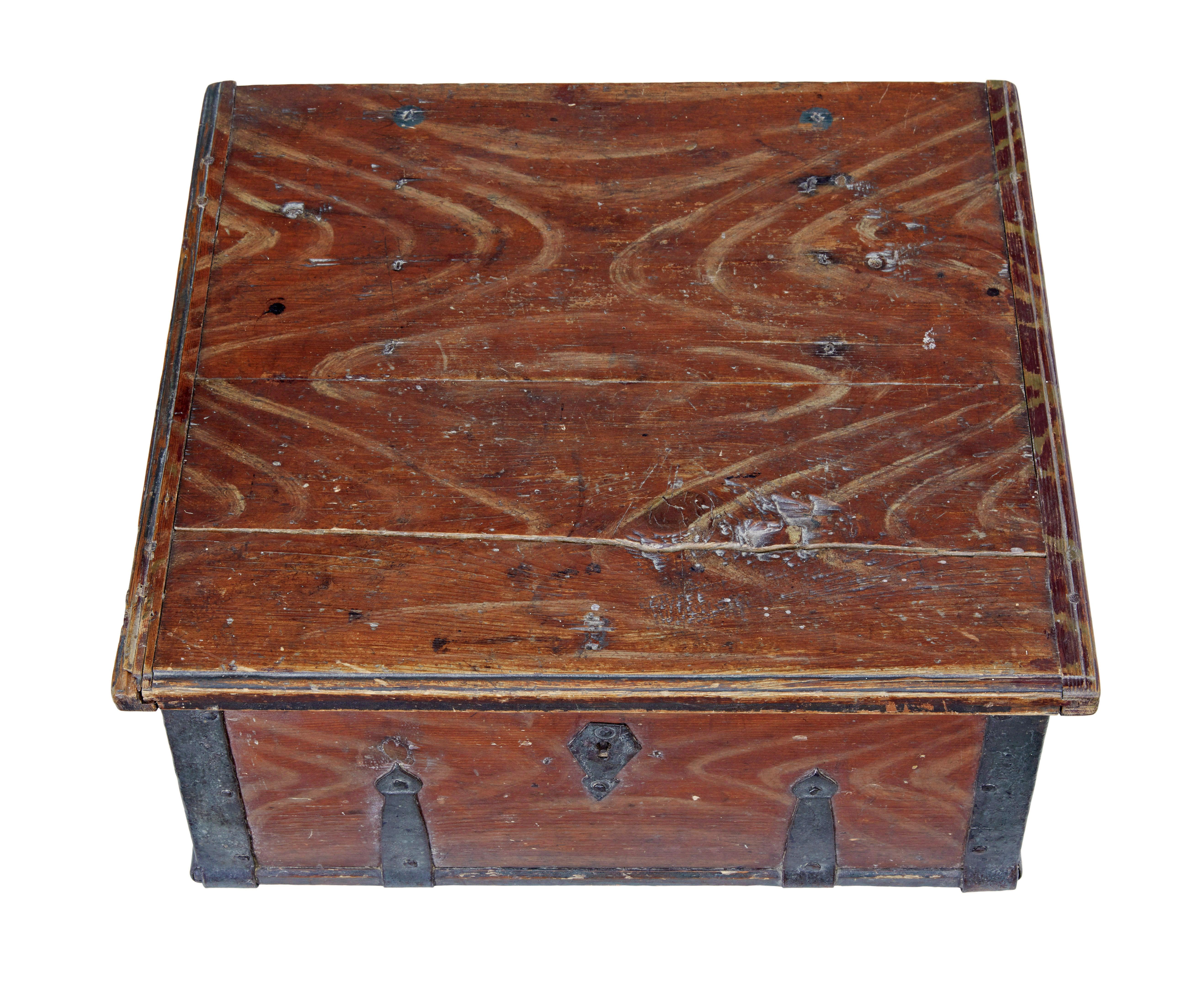 Scandinavian hand painted 19th century pine strong box circa 1840.

Good example of traditional rustic Swedish woodwork.  Painted in a russet red paint with hand painted cream drags.  Original iron strap work and hinges, also the original lock, but