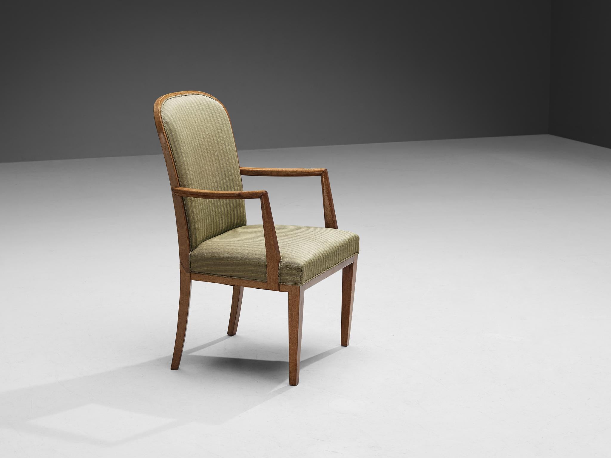 High back chair, oak, fabric, Scandinavia, 1950s.

This high back chair strongly resembles the design vocabulary by the Swedish designer Carl Malmsten. The unique lines and curves of the design are striking and the tapered wooden legs complement its