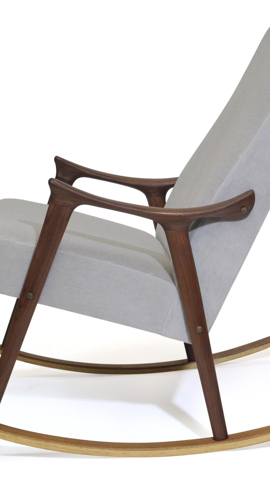 High-back rocking chair designed by Ingmar Relling crafted of a solid teak wood frame with sculpted arms, newly upholstered in off-white alpaca mohair.