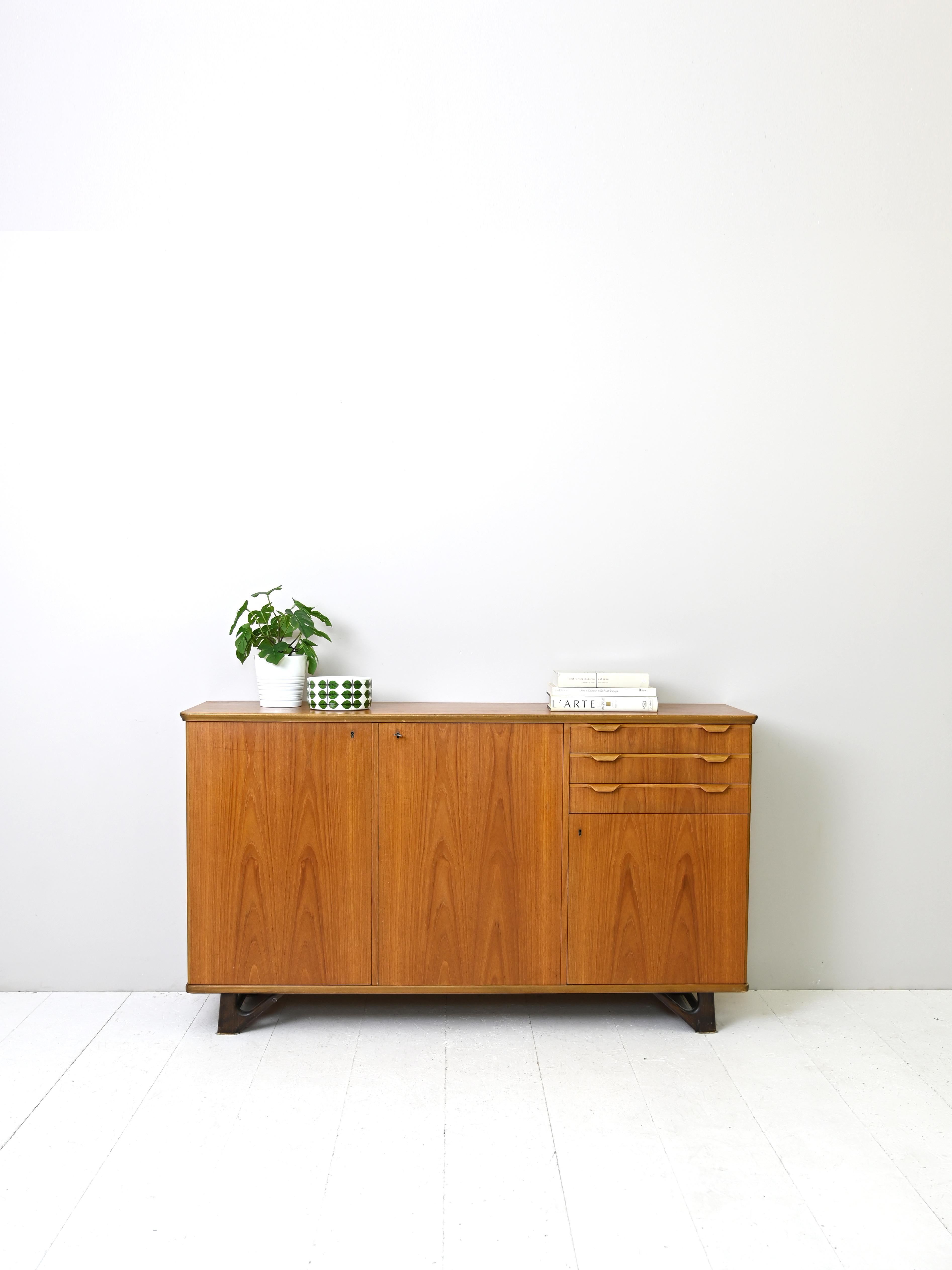 Vintage sideboard of Scandinavian manufacture with three drawers.

A capacious piece of furniture with a distinctive appearance. On one side is a storage compartment with hinged doors and on the other side are three drawers and a small space also
