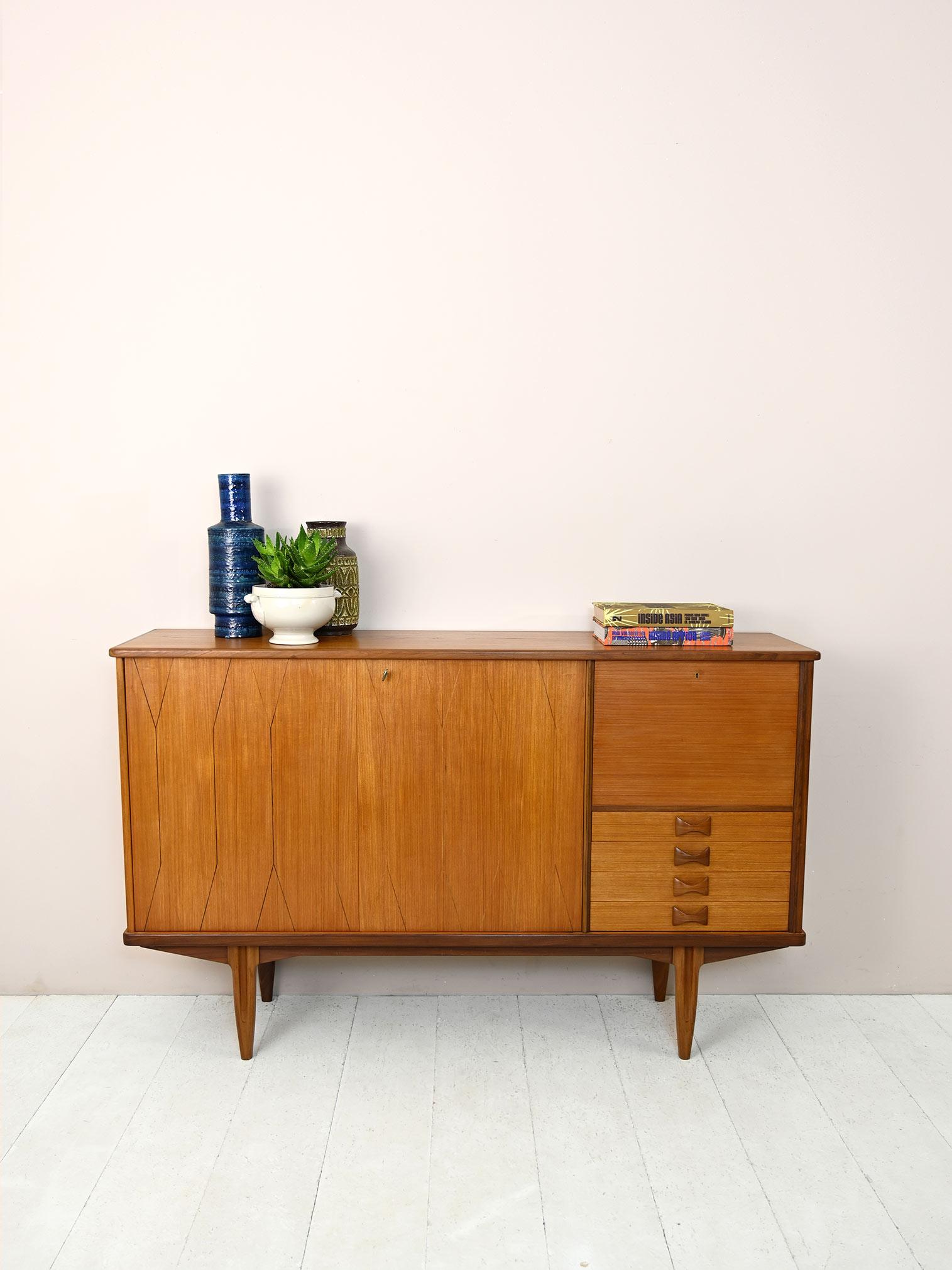 Nordic modernism sideboard from the 1960s.

A piece of furniture with a strong character and mid-century taste. 
Consisting of a storage compartment with hinged doors on one side, and on the other there are 4 drawers and a compartment with a