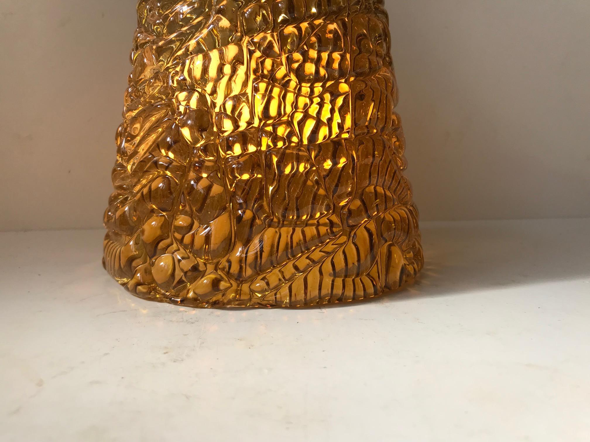 A rare semi-conical hanging light designed by Carl Fagerlund and manufactured by Orrefors in Sweden during the 1960s. The thick textured golden honey colored crystal glass is kept in place by 3 brass screw connected to a brass center stem/pole. Its