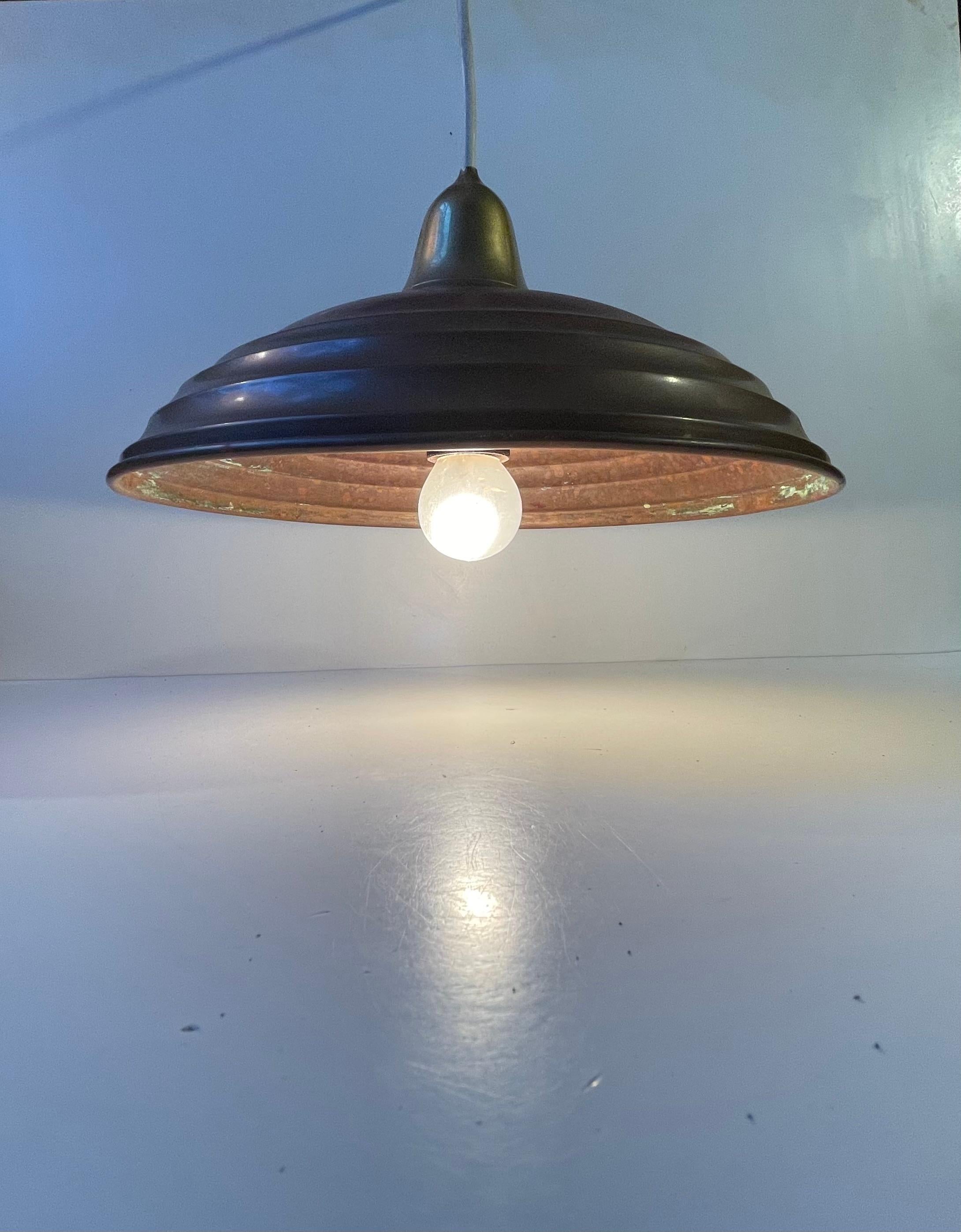 A 1920s or 30s raw and original industrial ceiling lamp fashioned from copper and brass. It retains its original patina and authenticity. Probably made in either Scandinavia or Germany. Original socket and 3 meters new cord installed. It has this