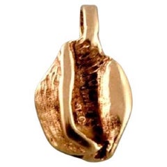 Scandinavian jeweler. Organically shaped pendant in 14 carat gold.