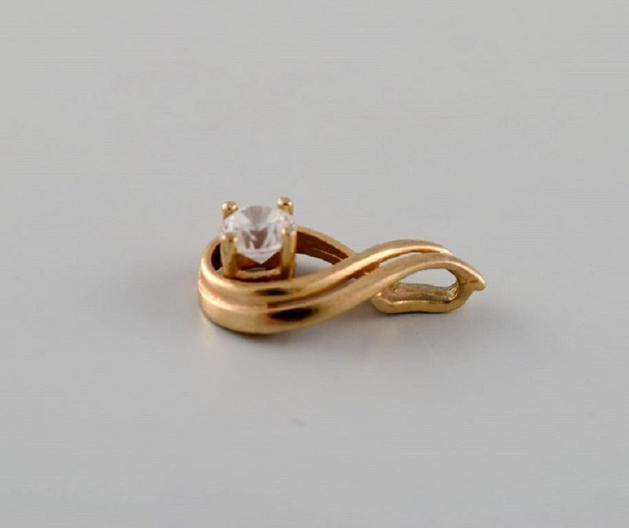 Modern Scandinavian jeweler. Pendant in 14 carat gold adorned with semi-precious stone. For Sale