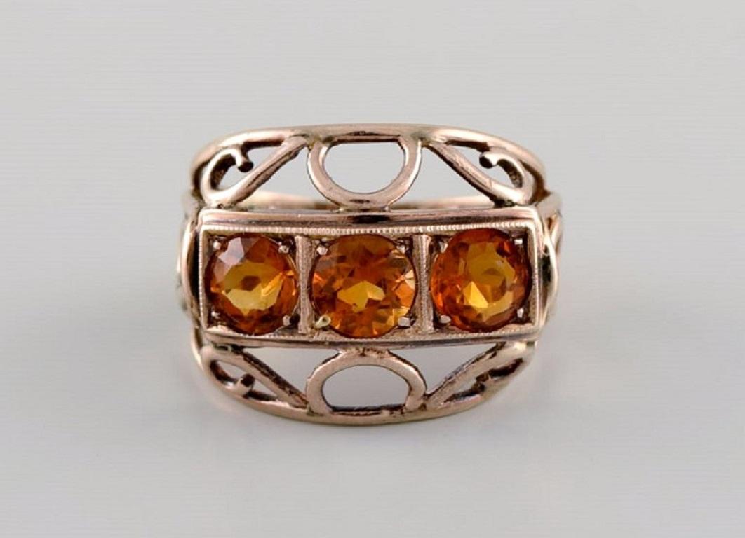 Scandinavian jeweler. Vintage ring in 8 carat gold adorned with three orange semi-precious stones. 
Mid-20th century.
Diameter: 18 mm.
US size: 7.75.
In excellent condition.
Stamped.
In most cases, we can change the size for a fee (USD 50) per ring.
