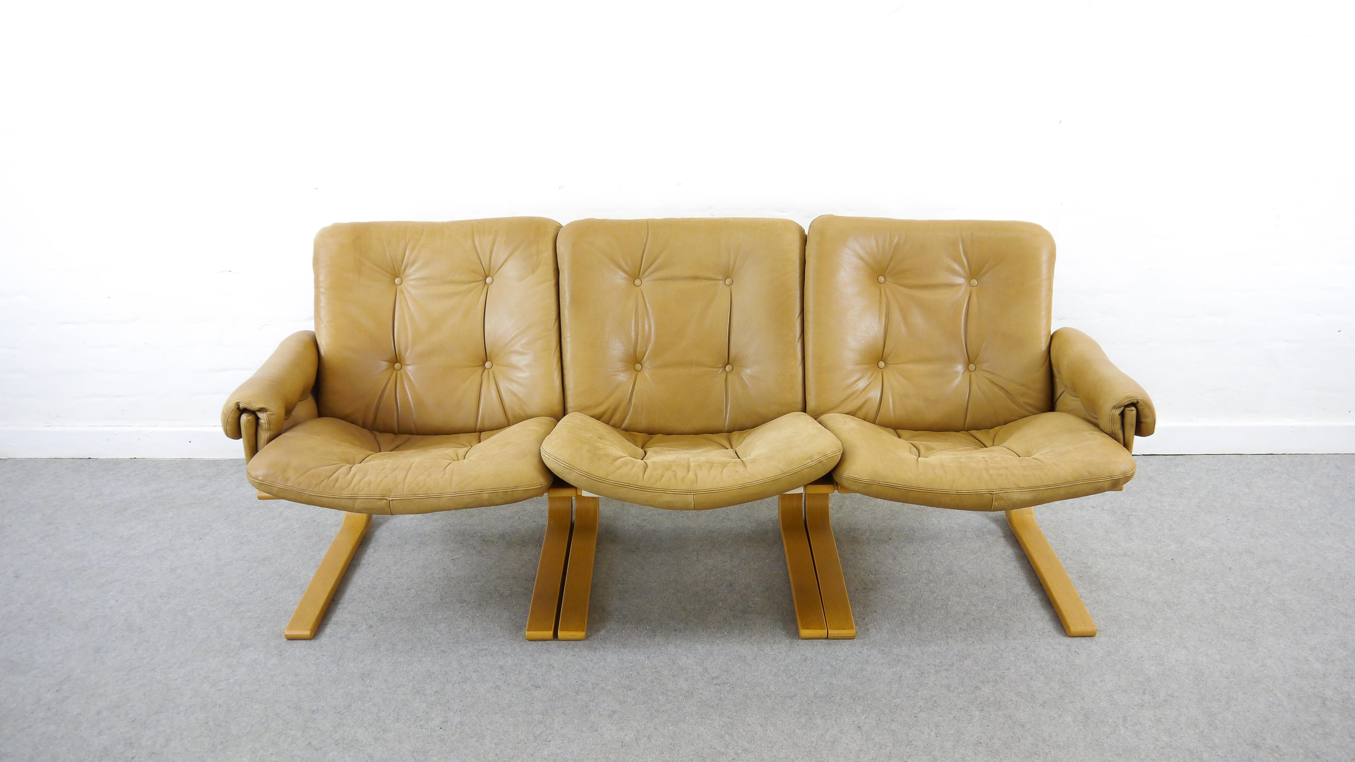 Scandinavian 3-seat Kengu Sofa by Elsa and Nordahl Solheim. Manufactured by Rybo Rykken & Co. Norway, 1970s. Upholstered in original brown or caramel leather. Cantilevered construction in wood with canvas and leather. Very comfortable. Good used