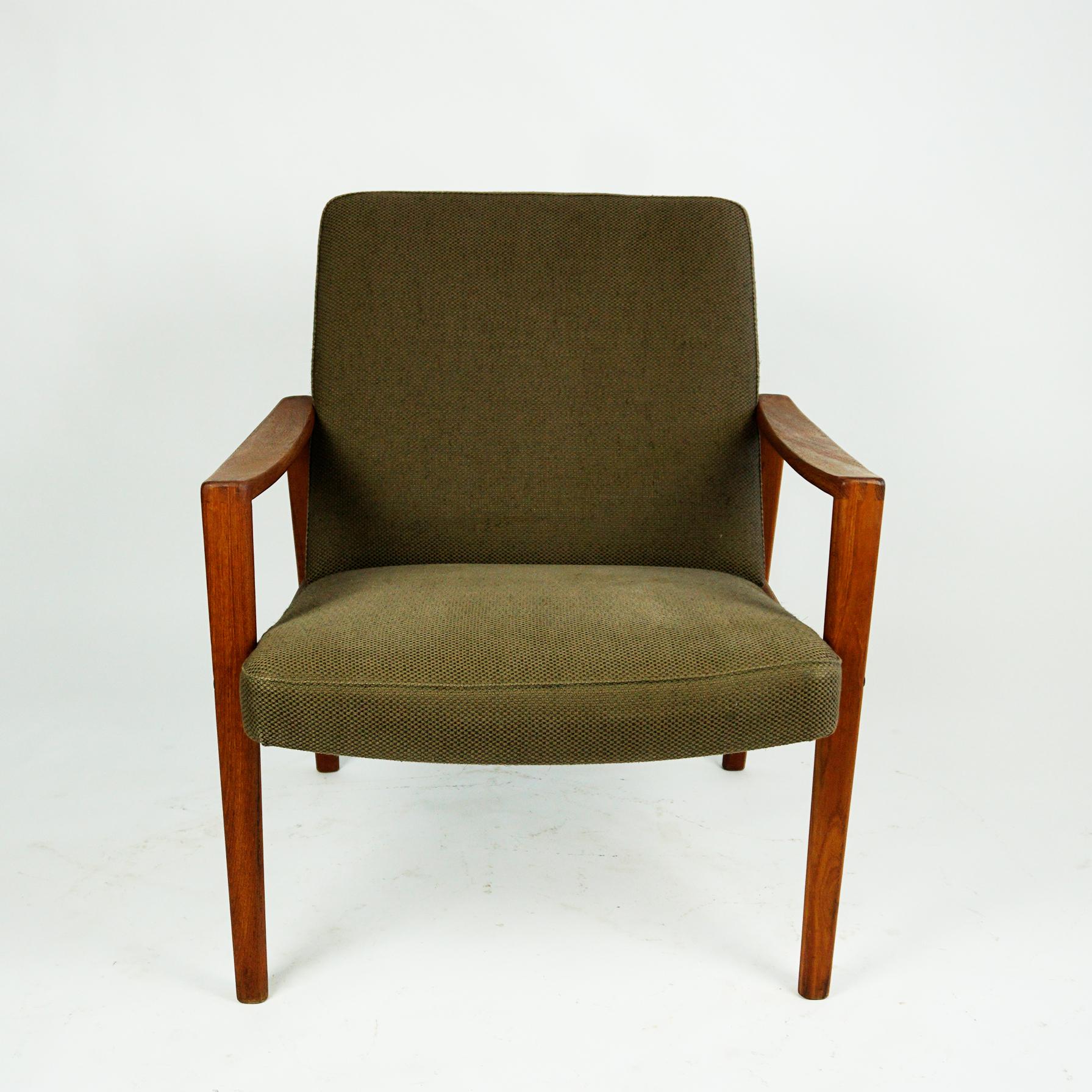 Comfortable 1960s Scandinavian teak easy chair in very good condition with original khaki green fabric and beautiful handcrafted details.
There is one more matching easy chair and a matching sofa available. 
Very comfortable lounge chair and