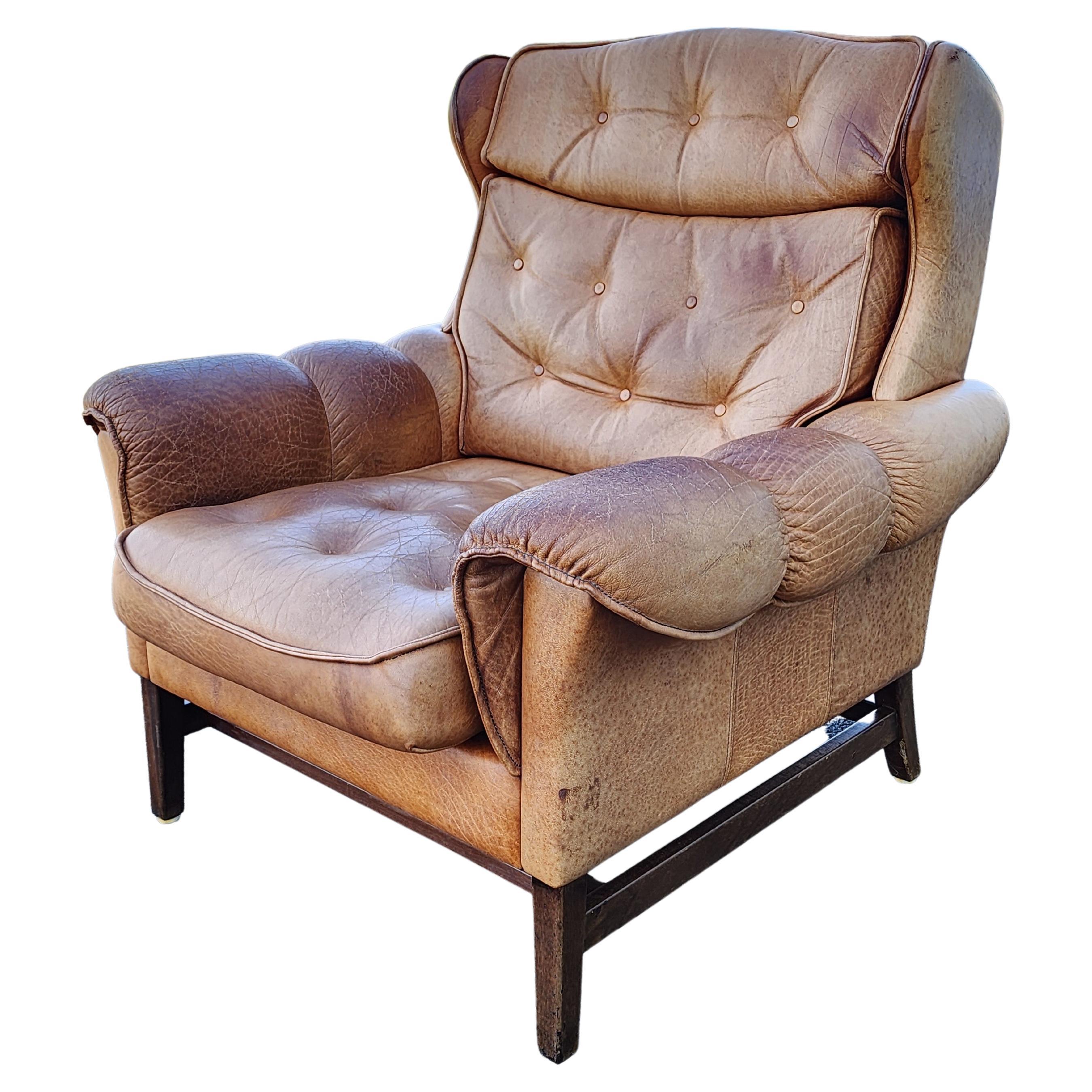 Handsome sculptural and comfortable. Those three words best tell the story of this danish leather chair from the nineteen seventies.  It is beautifully stuffed and has the surface of a warm, aged patina. This chair is turnkey and ready to go.
Please