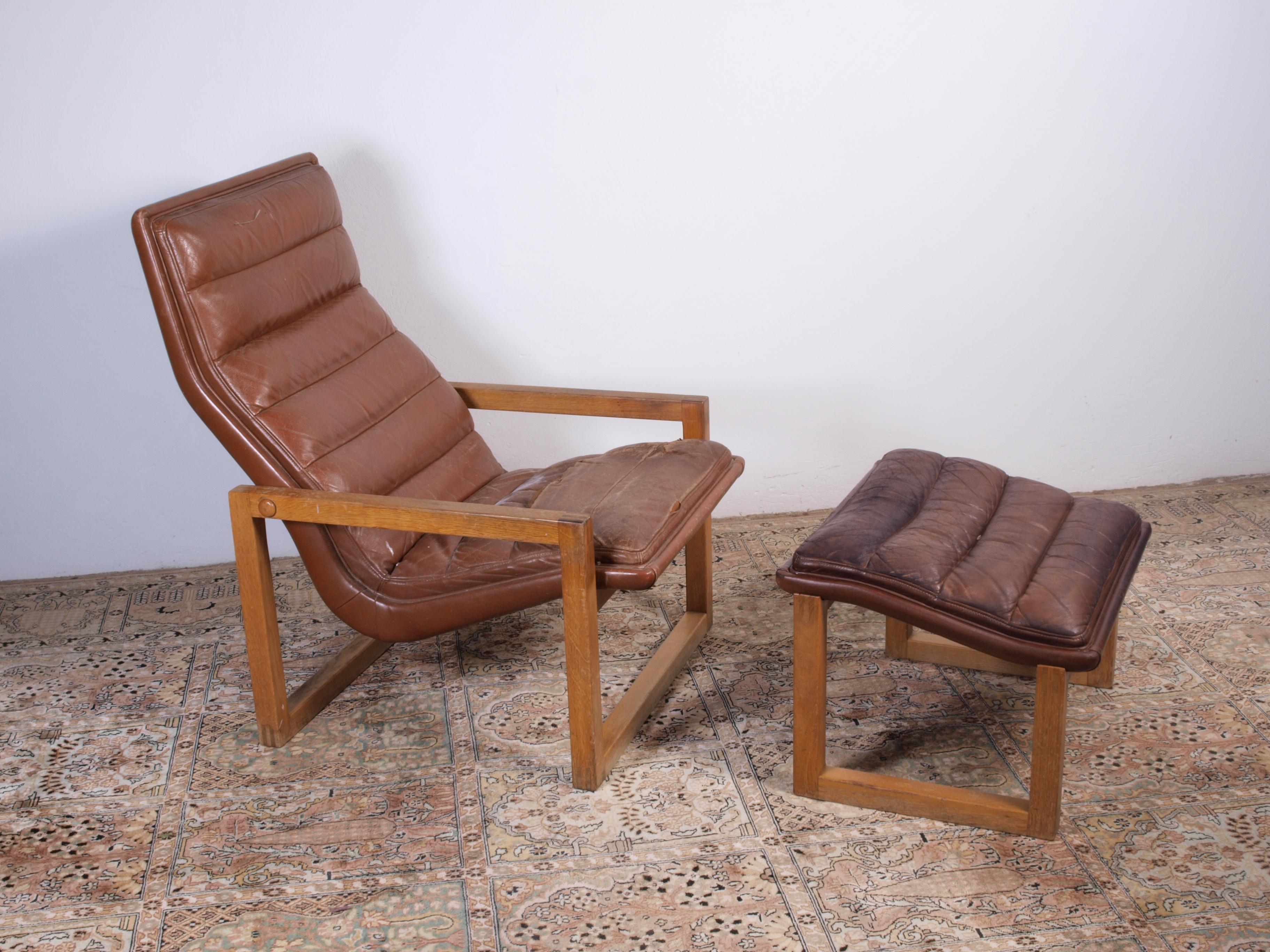 Vintage leather armchair + ottoman from an unknown designer. Fine stitched joints and solid wood. Threads to Arne Norell, Børge Mogensen, and other Scandinavian architects.

Requires reupholstering for both the chair and ottoman