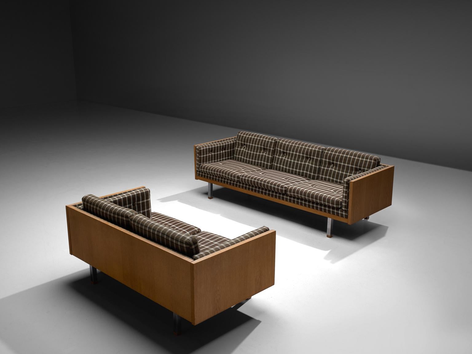 Jydsk Mobelvaerk, three and two-seat sofa, in oak, metal and fabric, Denmark, 1960s.

Scandinavian living room set, a two and three-seat sofa. The frame consist of oak with cubic metal legs, which provide an open look to the quite solid seating of