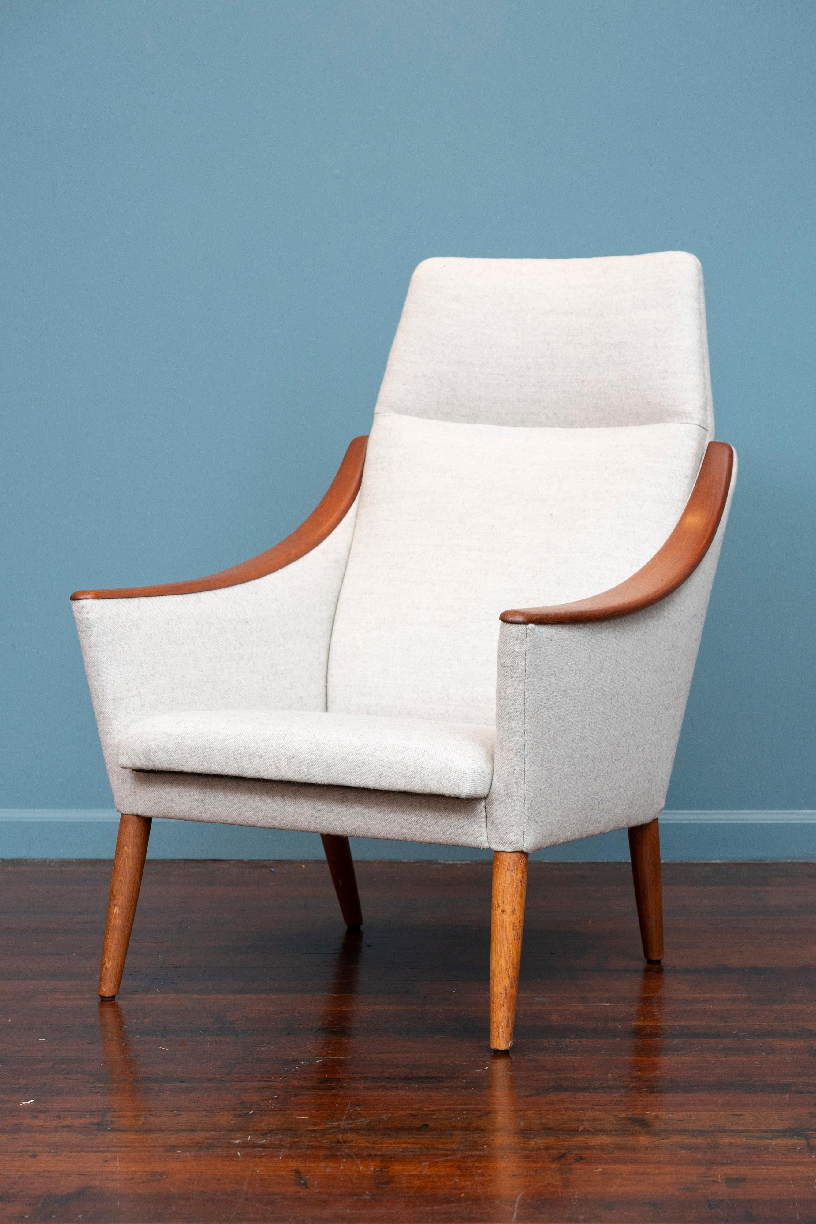 Scandinavian Modern high back lounge chair, Denmark. Featuring sculptural teak arms with a relaxing pitch high back make this a striking reading chair. Completely restored and newly refinished, ready to install and enjoy. Upholstered in a very pale