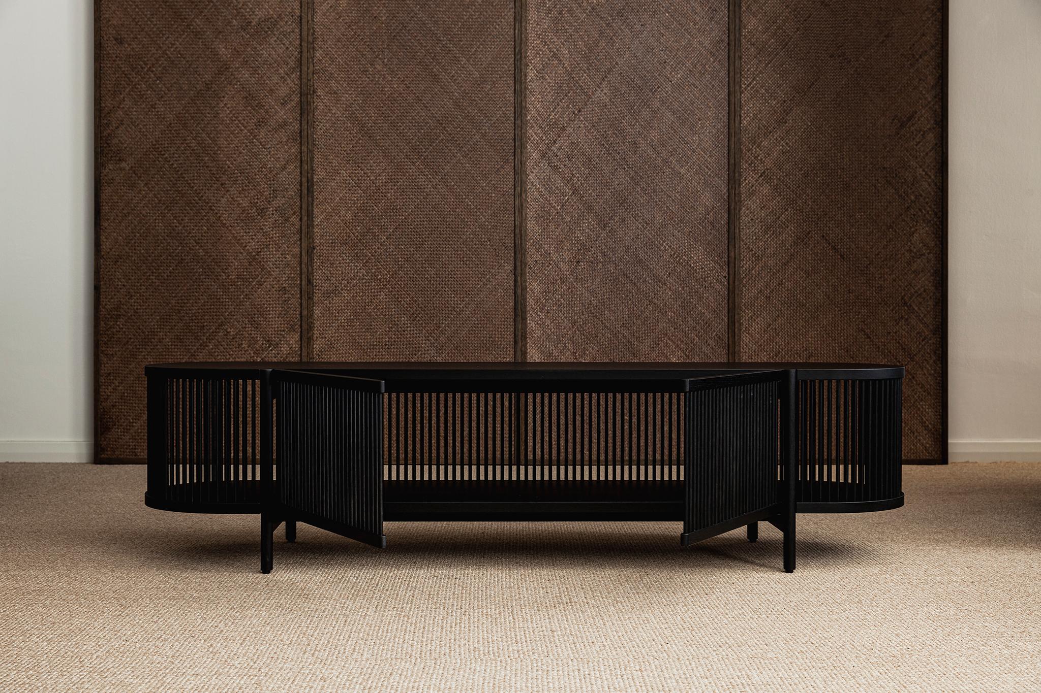 Low sideboard Bastone // black oak 
Designed by Antrei Hartikainen, 2022

Dimensions : H. 50 cm / W. 200 cm / D. 53 cm

Model shown in the picture : 
- Color : Black oak 
- With doors

Designed by the award-winning master cabinet maker and