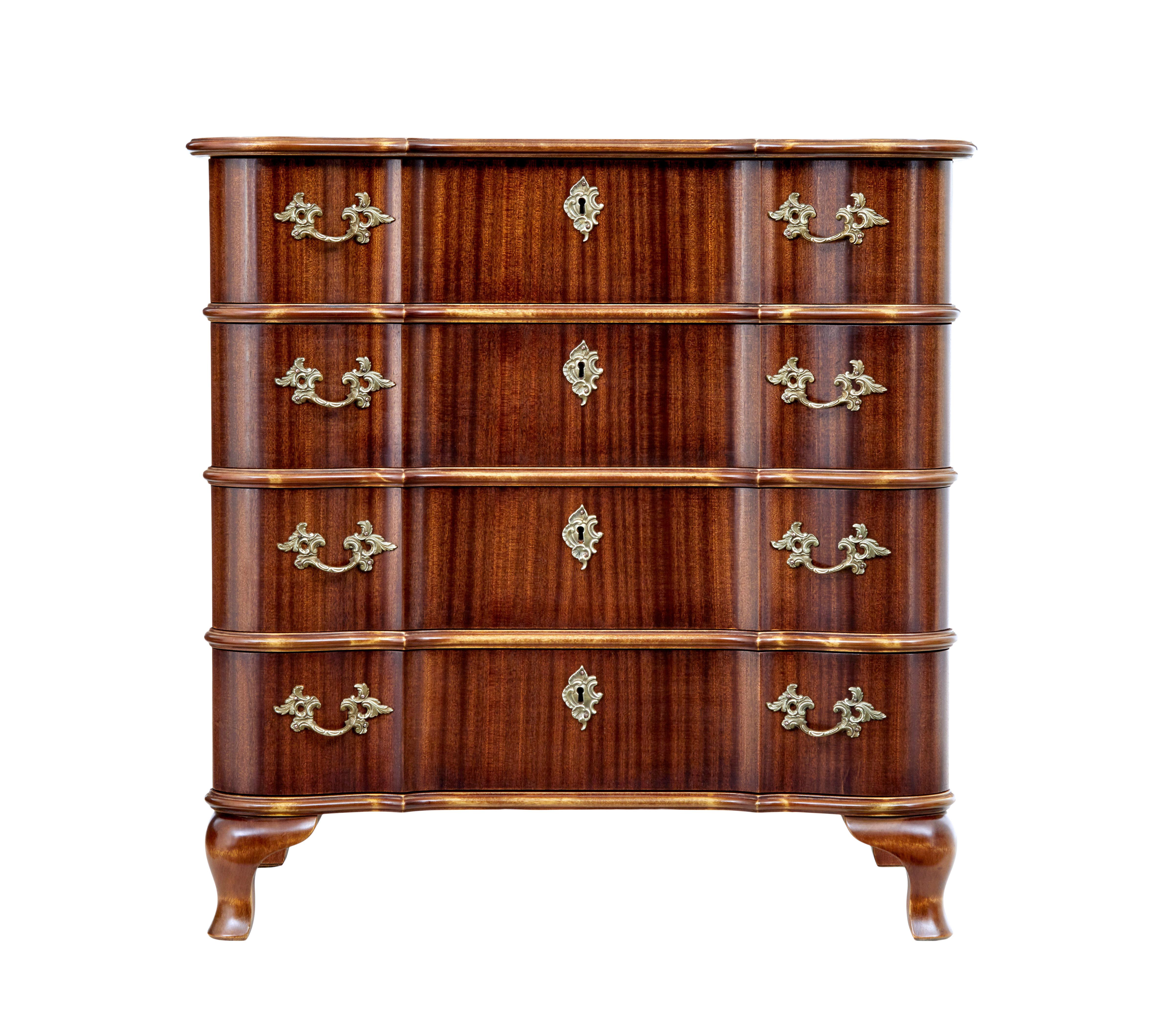 Scandinavian midcentury Baroque Revival chest of drawers circa 1950.

Good quality mahogany veneered chest of drawers, very much in the Baroque taste. Shaped top with 4 block fronted drawers below, each fitted with ornate handles and escutheon