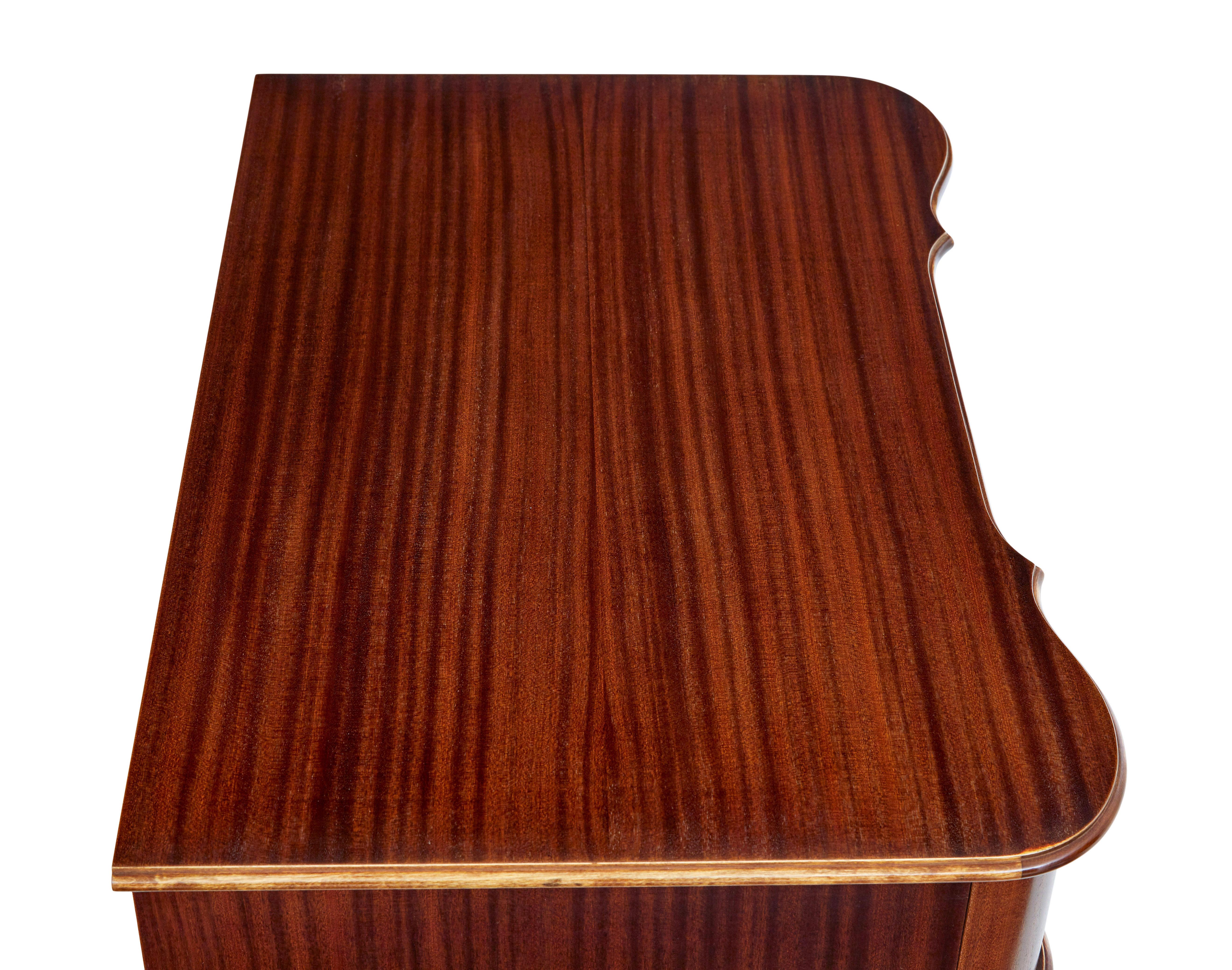 Scandinavian mid century baroque revival chest of drawers circa 1950.

Good quality mahogany veneered chest of drawers, very much in the baroque taste.  Shaped top with 4 block fronted drawers below, each fitted with ornate handles and escutheon