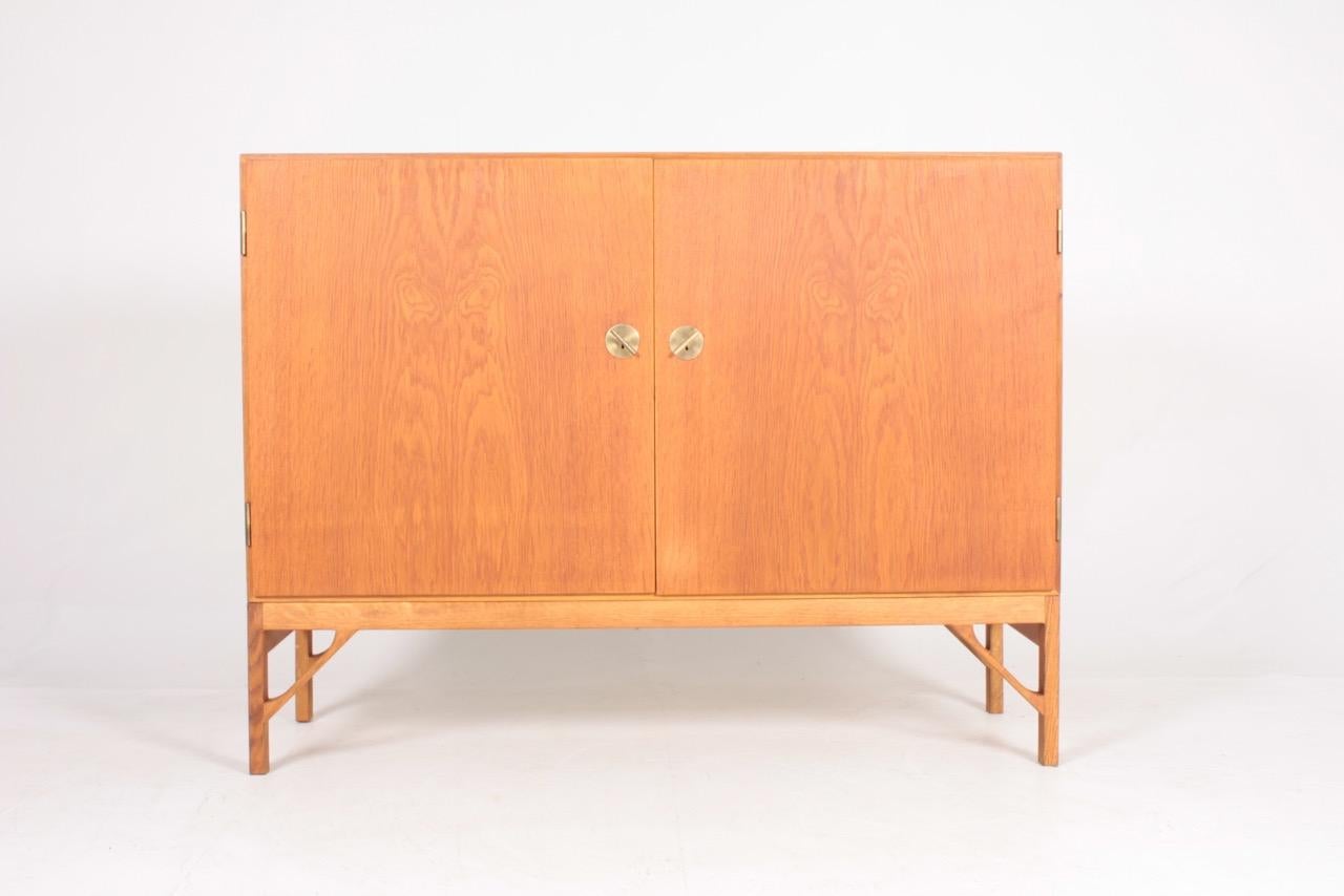 China cabinet in all oak with stunning brass hardware and maple Interior. Designed by MAA. Børge Mogensen in 1958, this piece is made by CM Madsen cabinetmakers Denmark in the 1960s. Great original condition.