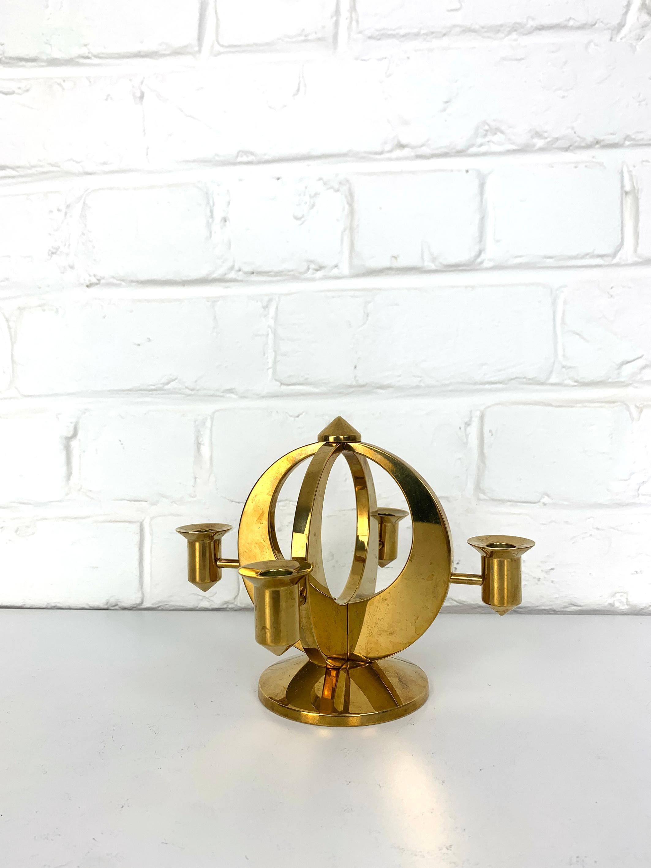 A Mid-Century Candelabra for 4 candles in solid brass (weight 3 lbs / 1.37 kg). 

Created and made by Arthur Petterson, he signed his candleholders “Arthur Pe Kolbäck”.

He was born in 1919 in Kolbäck, Sweden, where he lived and worked all his live.