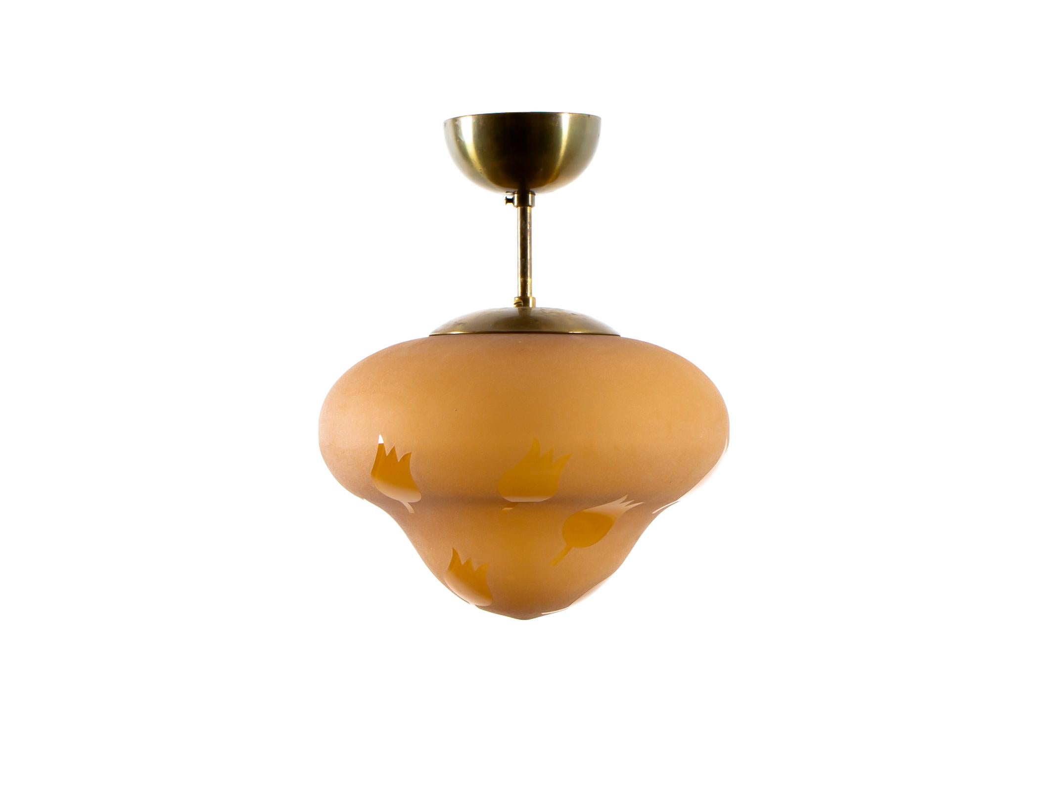 Modernist ceiling light in brass with decorated shades in blown glass. Designed and made in Norway from cirka 1950s second half. The lamp is fully working and in good vintage condition. It is fitted with one E27 bulb holder (works in the US), with a