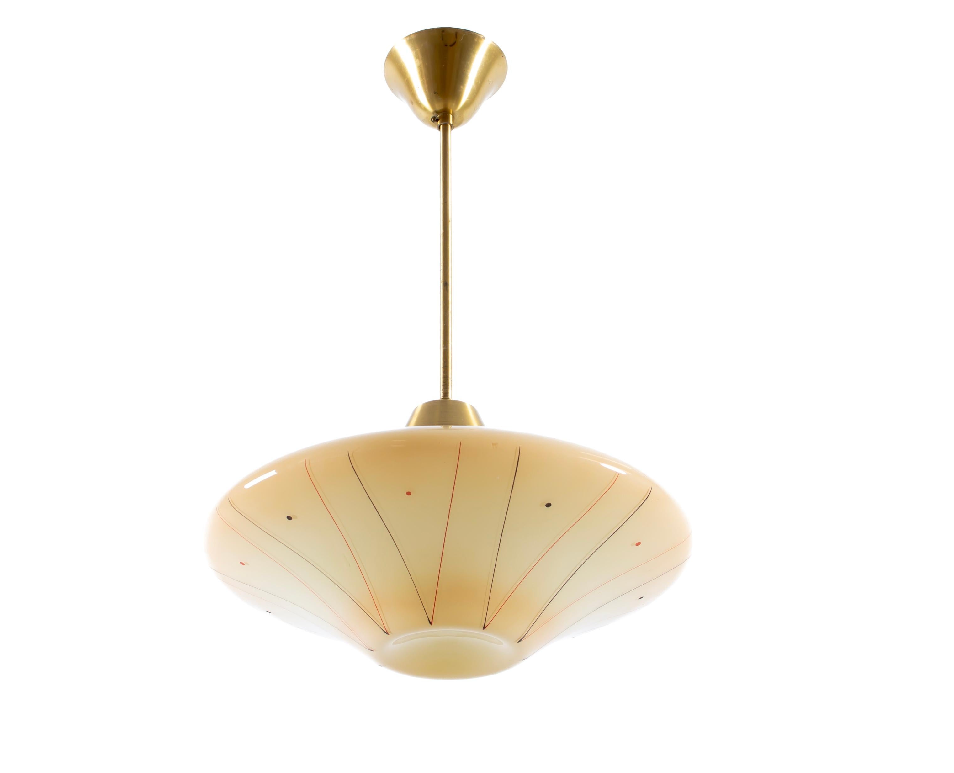 Modernist ceiling light in brass with decorated shade in blown glass. Designed and made in Norway from cirka 1950s second half. The lamp is fully working and in good vintage condition. It is fitted with one E27 bulb holder (works in the US), with a