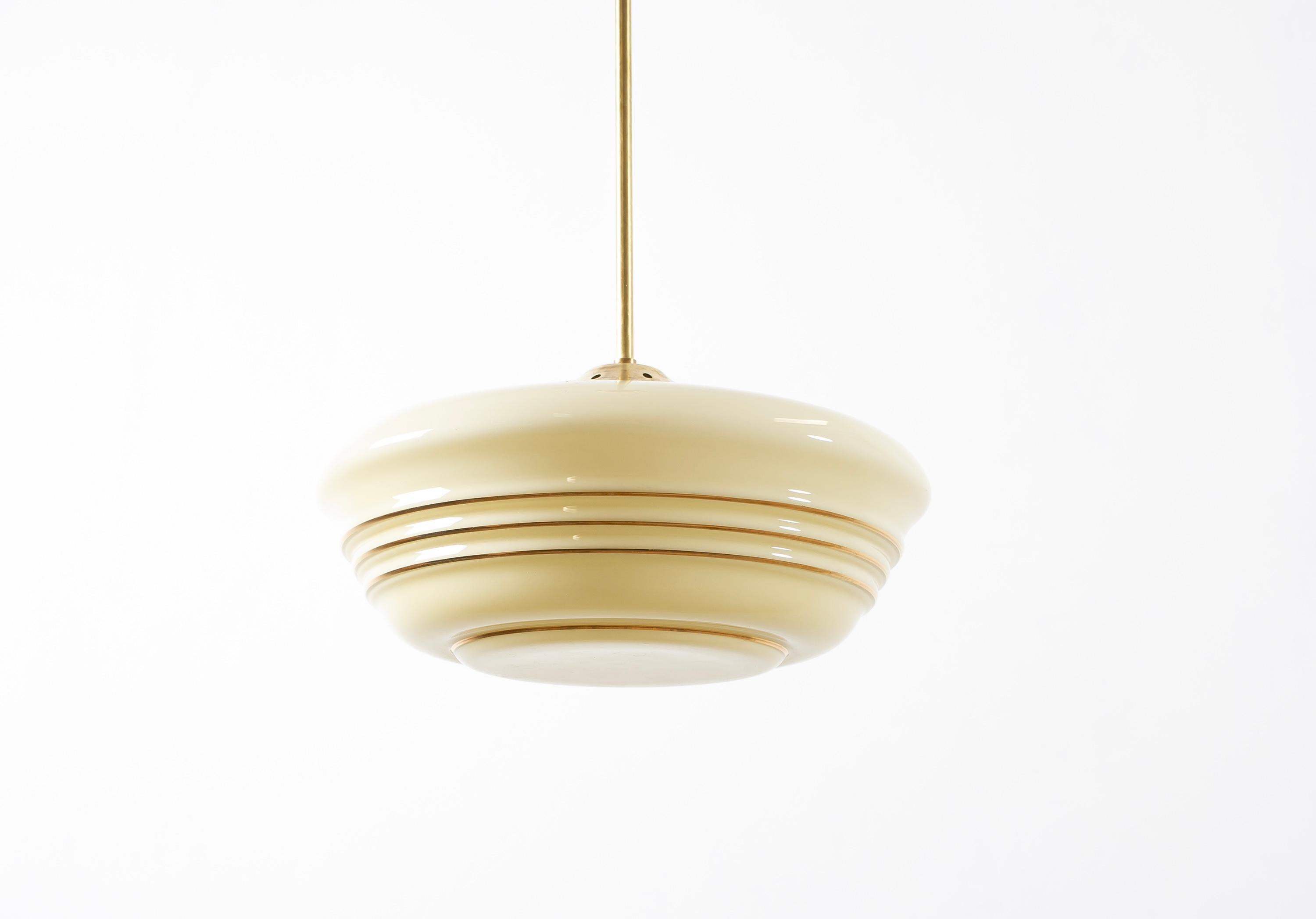 Modernist ceiling light in brass with decorated shade in blown glass. Designed and made in Norway from cirka 1950s second half. The lamp is fully working and in good vintage condition. It is fitted with one E27 bulb holder (works in the US), with a