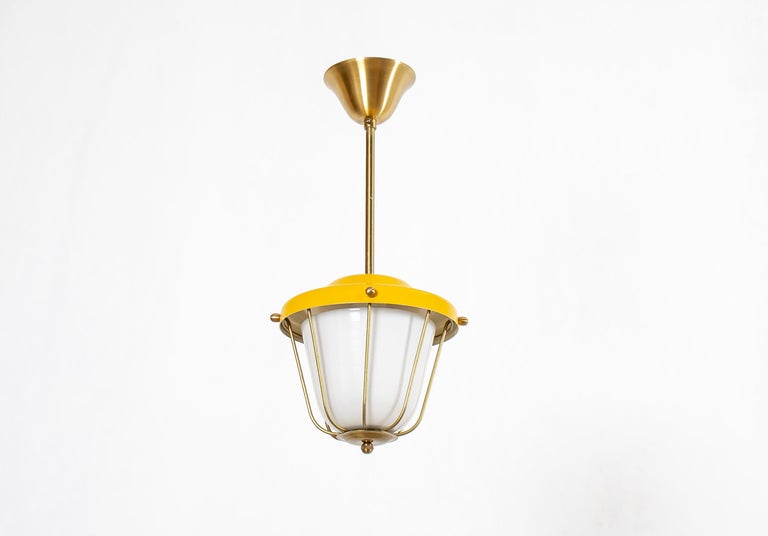 Modernist ceiling light in brass with shades in painted aluminum and opaline glass. Designed and made in Norway from cirka 1960s first half. The lamp is fully working and in good vintage condition. It is fitted with one E27 bulb holder (works in the