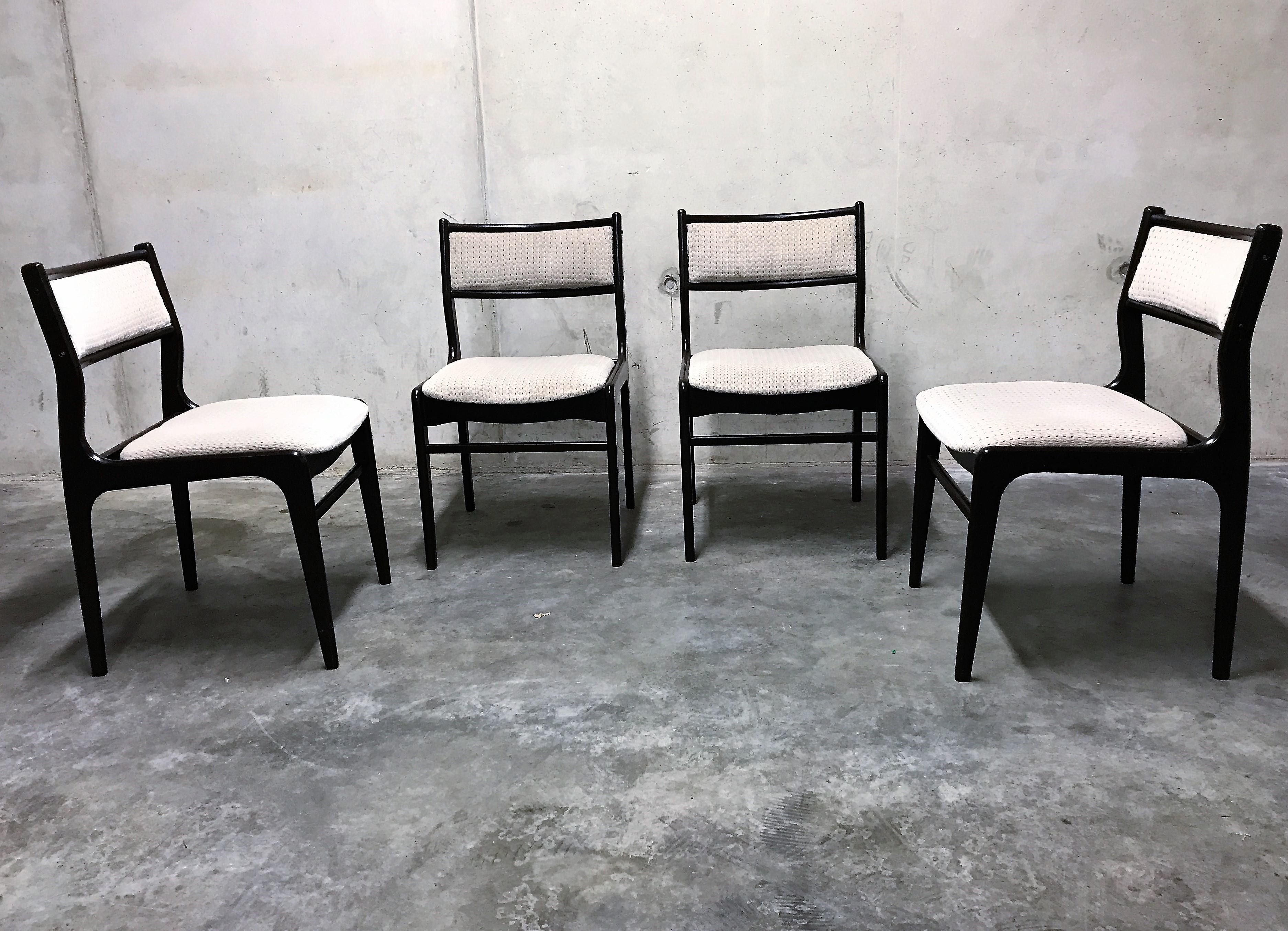 Set of 4 Mid-Century Modern scandinavian designed dining chairs.

The chairs are made of a very dark brown teak wooden frame ophulsotered with grey fabric.

The upholstery will be renewed to the same grey so that it looks spotless.

These