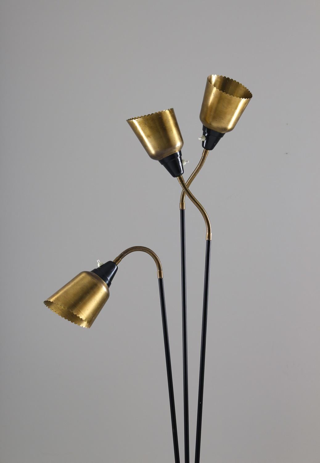Beautiful midcentury Scandinavian floor lamp model 7297 by Swedish manufacturer Boréns. 
The lamp consists of three light sources, hidden behind perforated brass shades, held by adjustable arms. 
This floor lamp is probably custom made by the