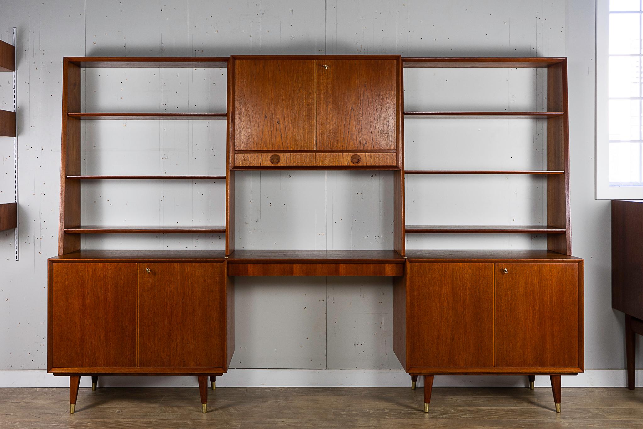 Teak Scandinavian wall cabinet circa 1960's. Smart storage solution, combining a drawered desk, open bookcases and three cabinets, all in one! Bookcase shelves are height adjustable, the center cabinet has an adjustable shelf as well, with a cut out