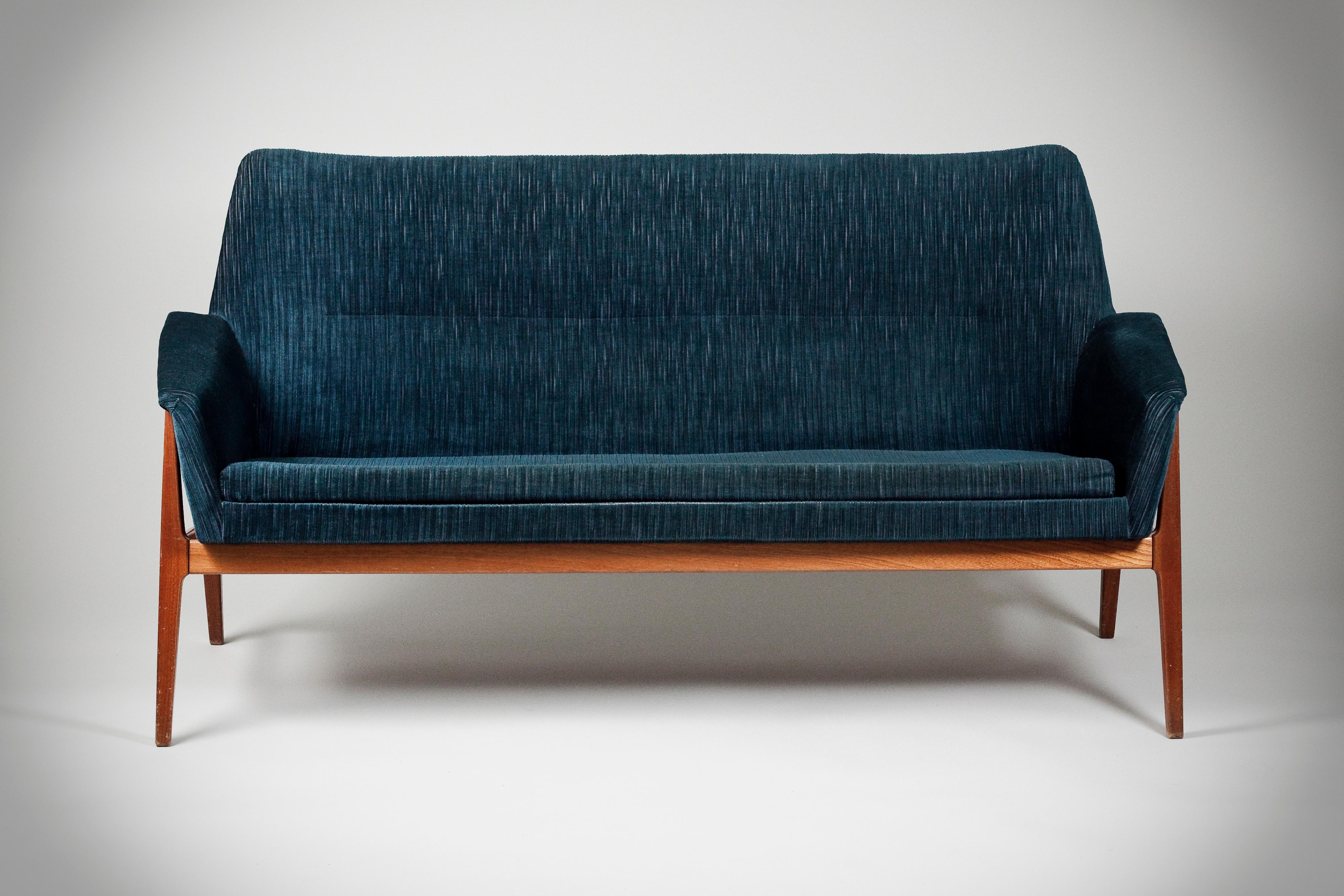 Light Scandinavian Mid-Century Modern blue sofa with teak legs. The sofa is equally beautiful from the back as the front.