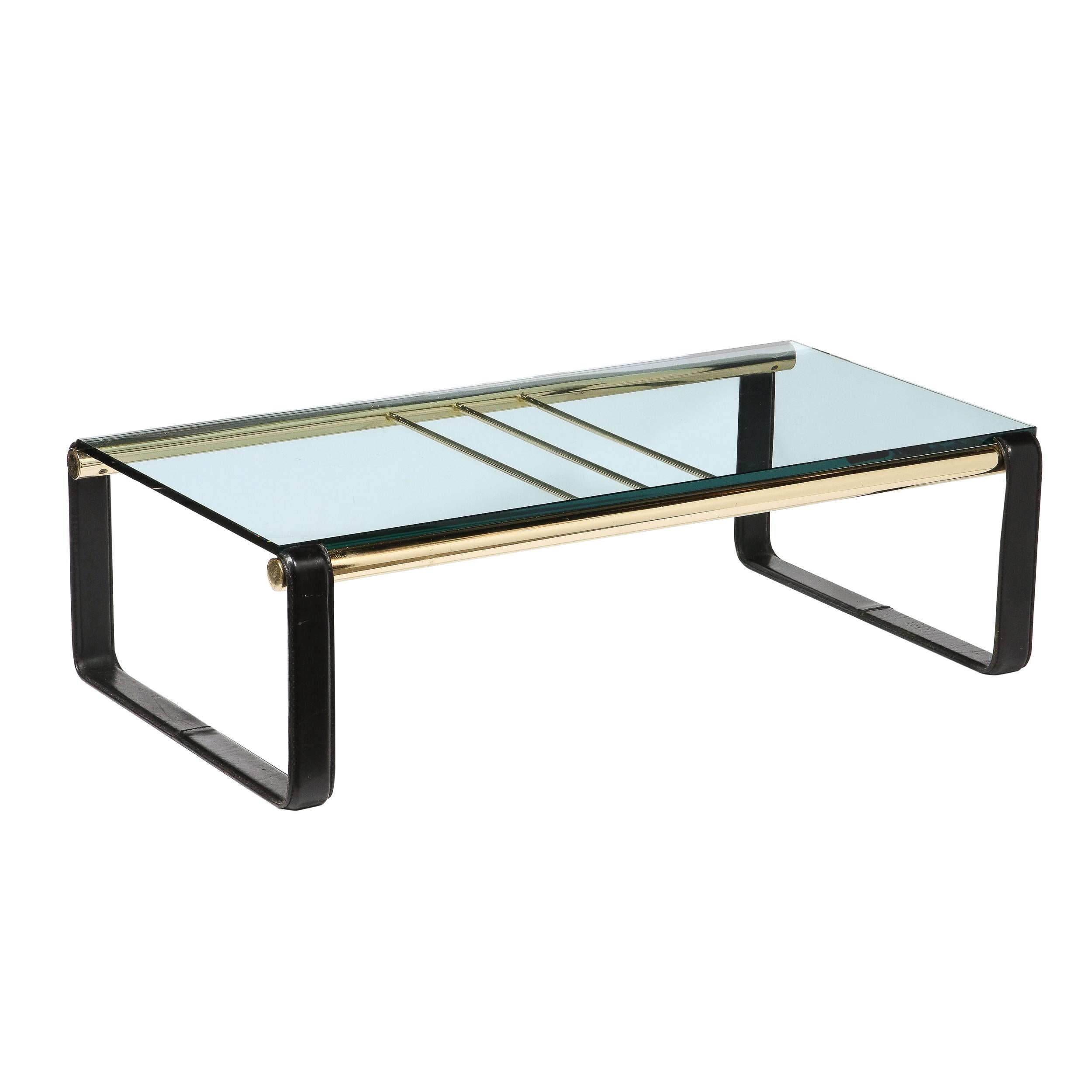 This elegant Mid-Century Modern cocktail table was realized in Denmark during the latter half of the 20th century. It features a rectangular body with rectilinear black leather supports on each end adjoined by lustrous brass cylindrical supports.