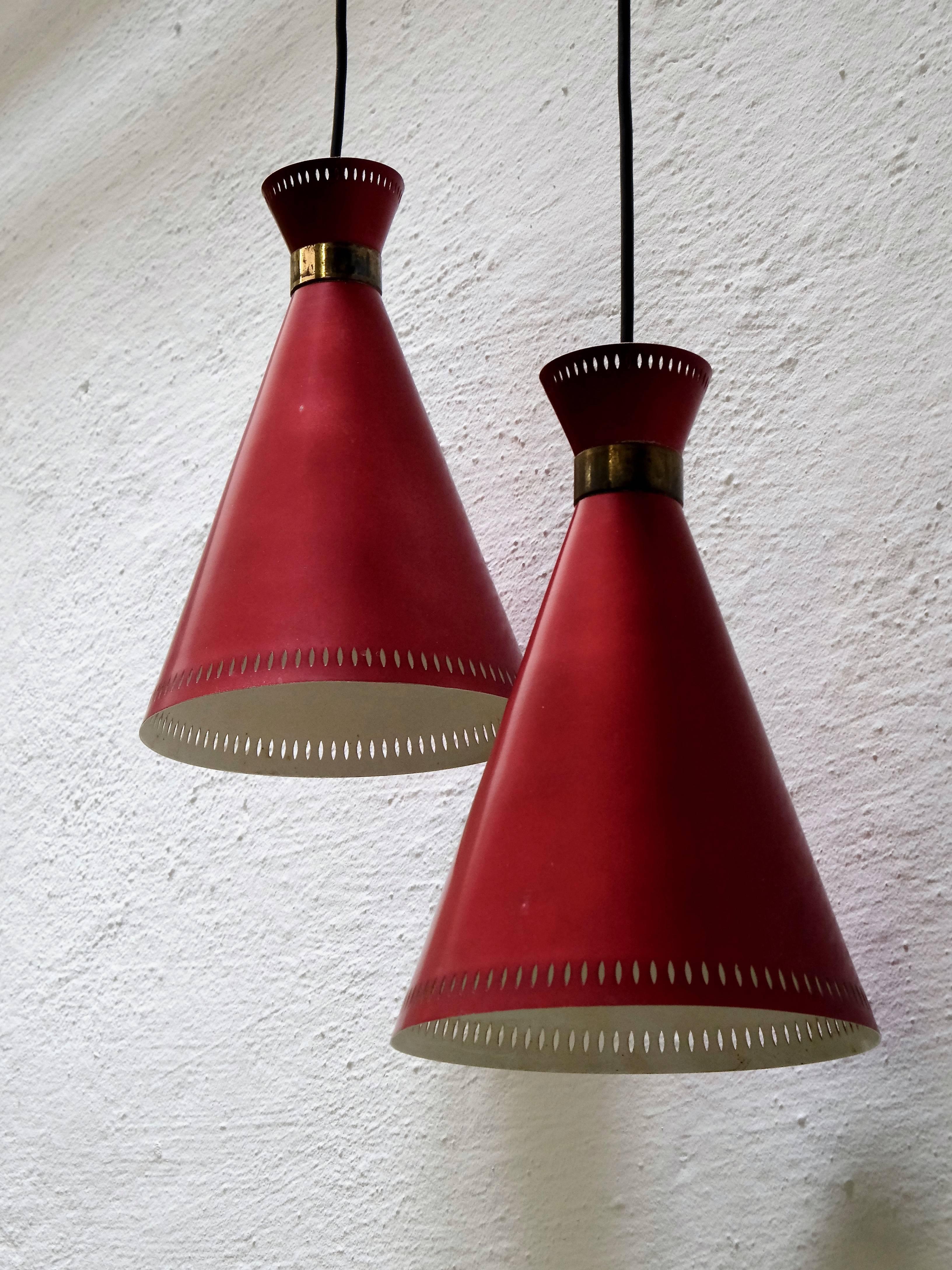1950s burgundy pierced shade with white inner surface by Finnish company Valinte. Brass detail.