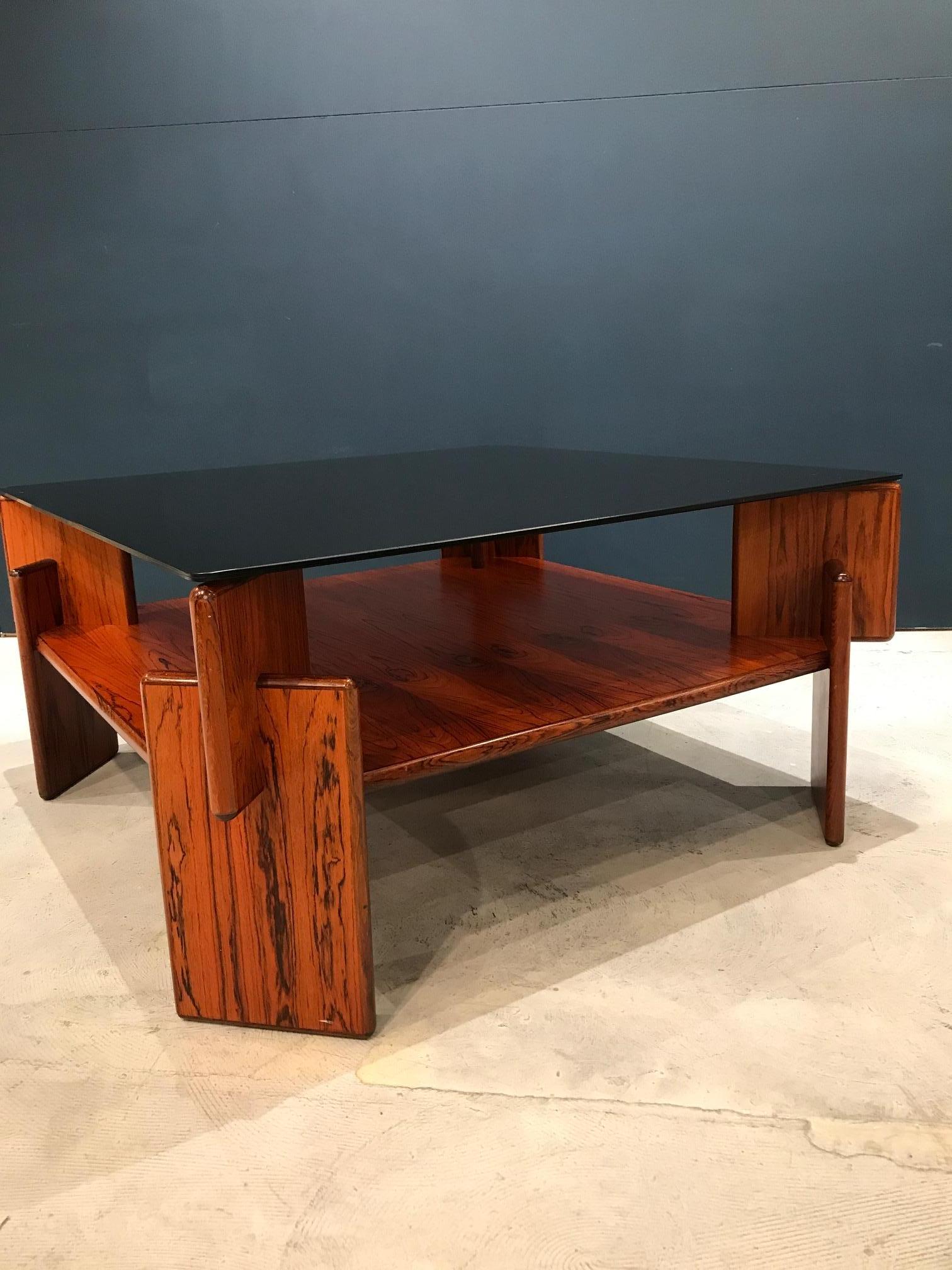 A rosewood and smoked-glass coffee table by Torbjorn Afdal, for Bruksbo Norway, 1970.

  