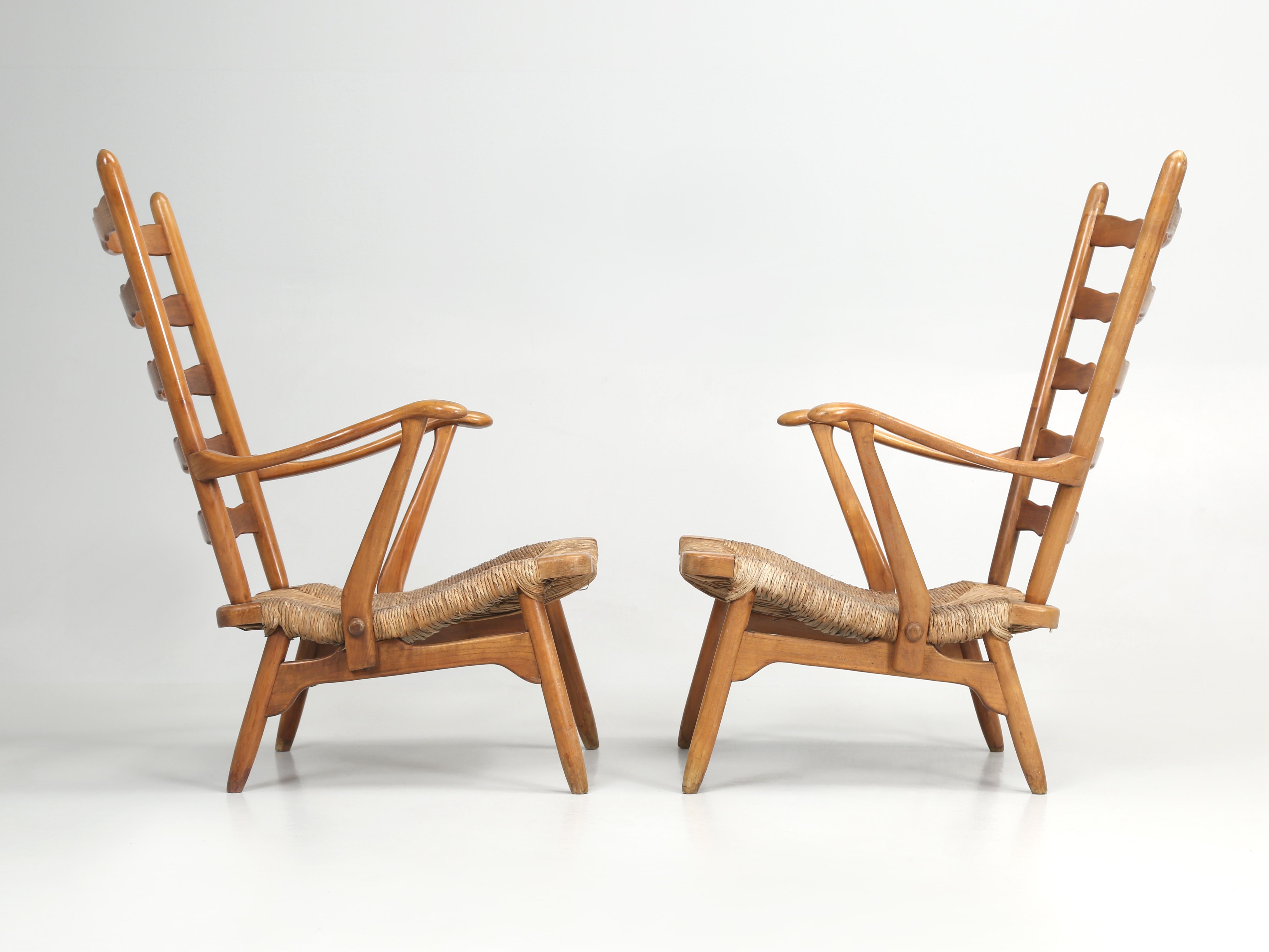 Pair of Mid-Century Modern Scandinavia Arm Chairs with Rush Hand-Woven Seating surfaces. The pair of Scandinavian Arm Chairs were left purposely unrestored when it comes to the clear-coating on the Scandinavian Arm Chairs wood frames. In our