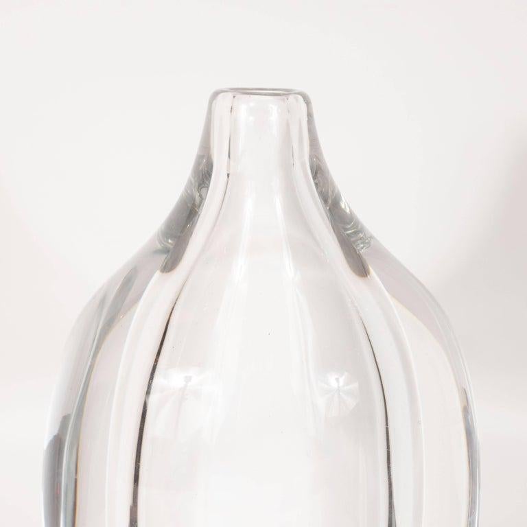Diese elegante und raffinierte Vase wurde von dem geschätzten schwedischen Glasstudio Orrefors um 1960 hergestellt. Sie hat eine eiförmige Form - mit einer konzentrischen Form derselben Form in der Mitte -, abgeschrägte Schultern und eine schmale