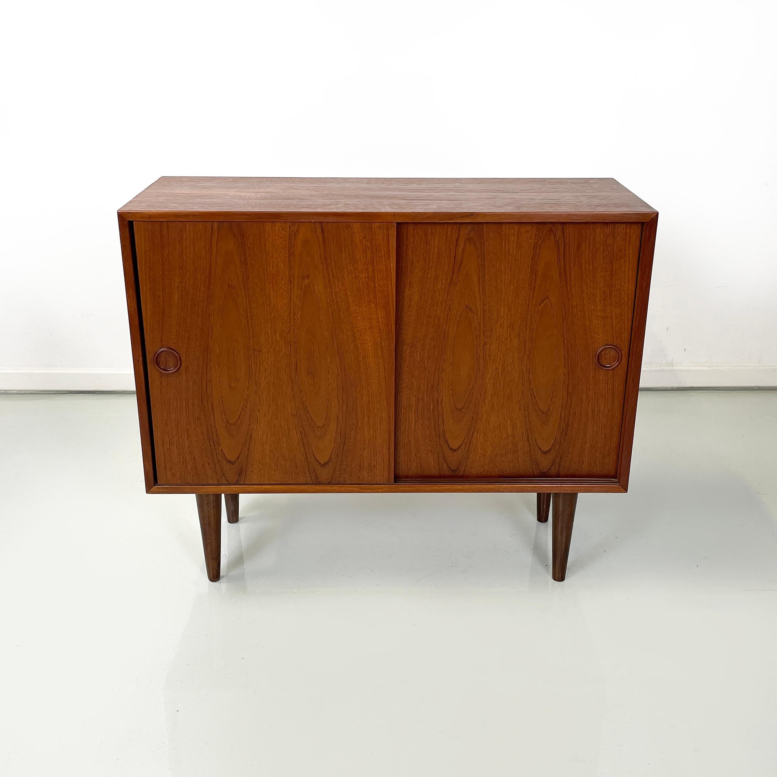 Scandinavian mid-century modern Sideboard in teak with two sliding doors, 1960s
Rectangular sideboard entirely made of teak wood. On the front it has two sliding doors with round handles. In one compartment there is a shelf, while in the other there