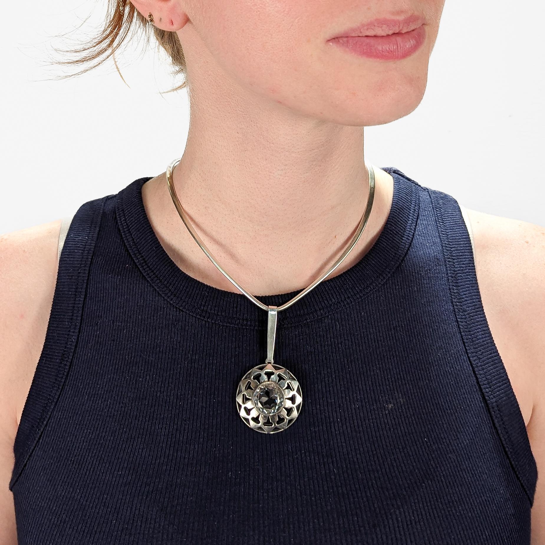 A fine Swedish modern pendant.

In solid silver with a bezel-set round cut rock crystal gemstone to the center of the pendant.

The pendant by Ge-ka Rolf Kaplan and is marked with a silversmith's initials 'G.K.'.

Simply a wonderful Swedish