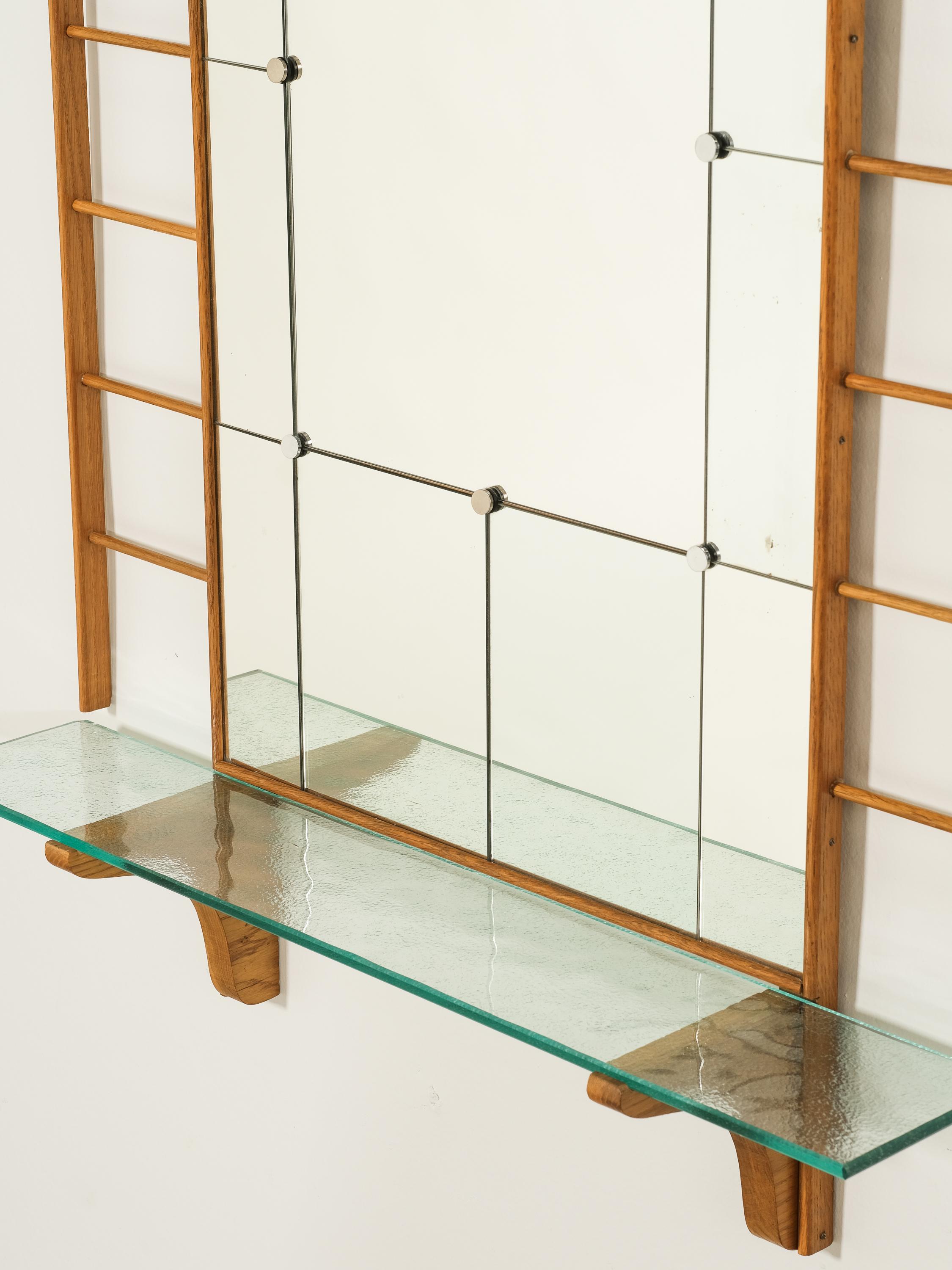 Add a touch of elegance to your home with our Scandinavian Mid-Century Oak Wall Mirror from the 1950s. Crafted with quality oak and featuring a glass shelf, this mirror not only adds a vintage charm to your decor but also provides convenient storage