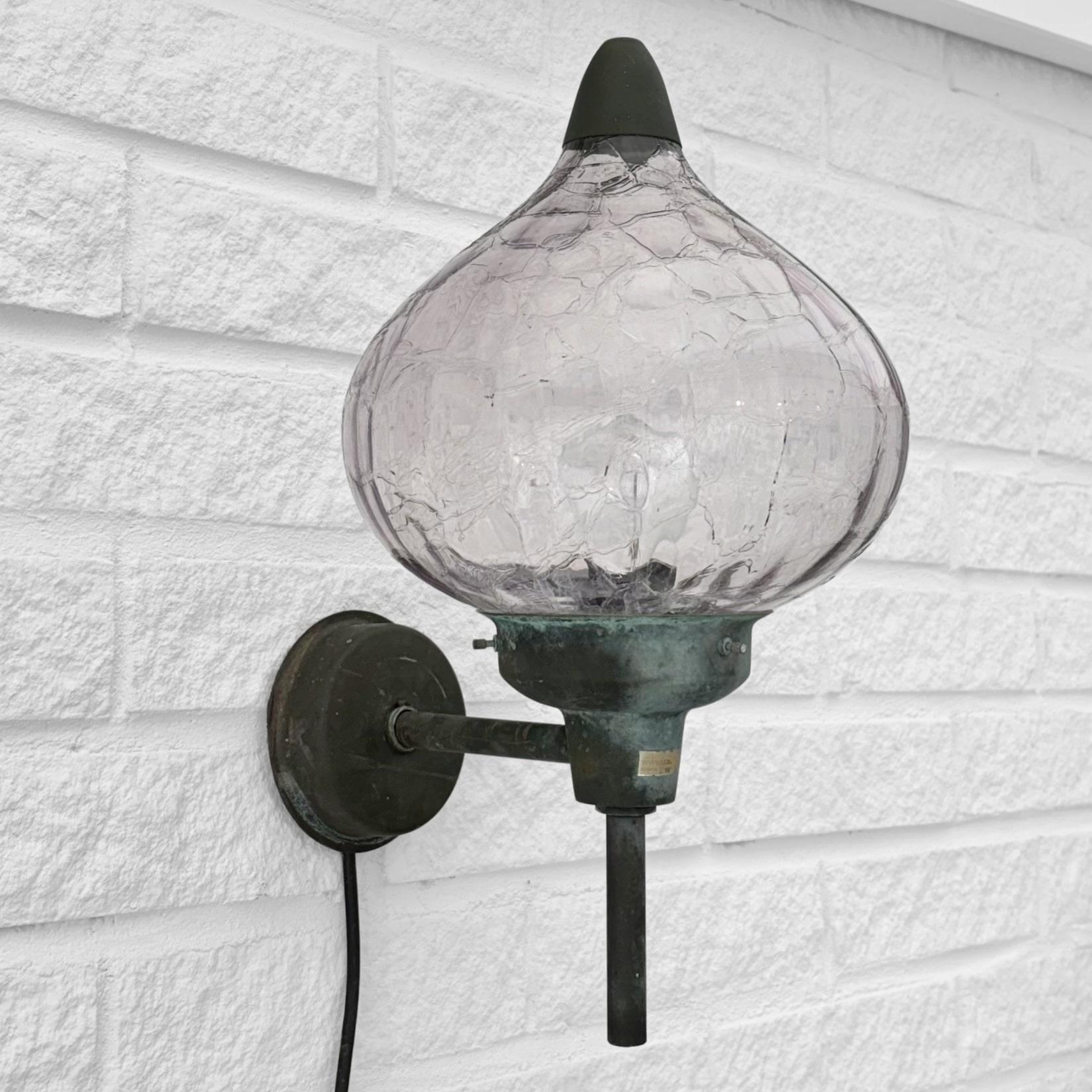 An organically shaped Scandinavian outdoor facade lamp, model 283, produced by the Swedish lighting manufacturer Westal in the 1970s. It’s crafted from solid copper with a beautiful deep green patina and features a bud-shaped glass shade in a subtle