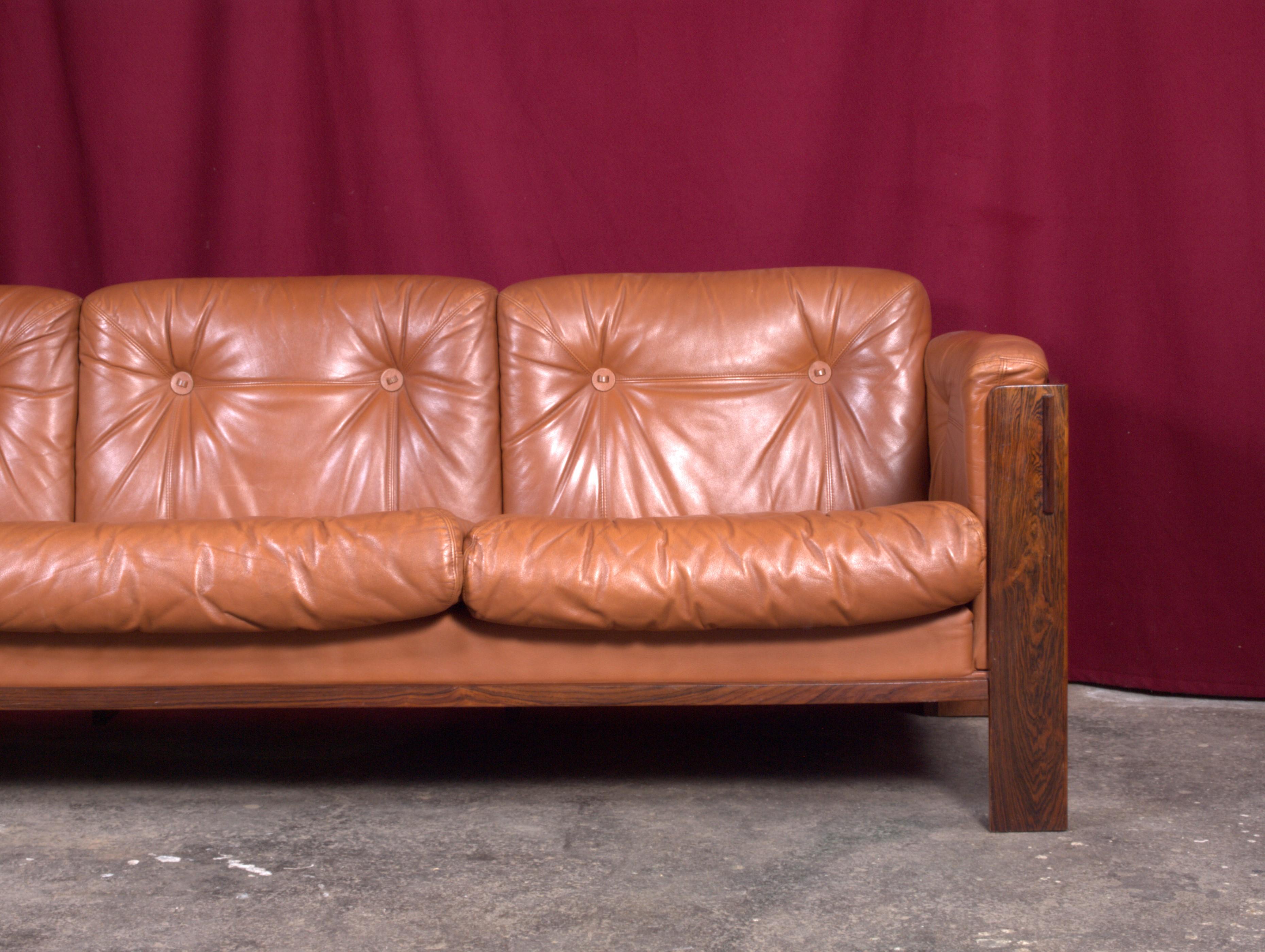 Extremely rare and special sofa from the 1960s / 1970s in rosewood and tan colored leather in very good condition. Perfectly patinated by the time. From the years of our most prominent designers and architects, most likely from Norway or