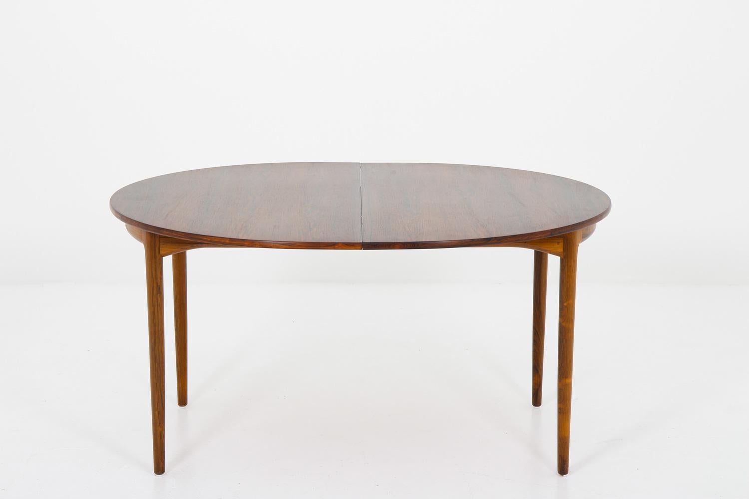 Rare dining table by Ib Kofod Larsen for Seffle Möbelfabrik, 1960s.
This large oval-shaped dining table is made with an impressive sense for quality and shows beatiful details. The table comes with two extending leaves that measure 45cm (17,7