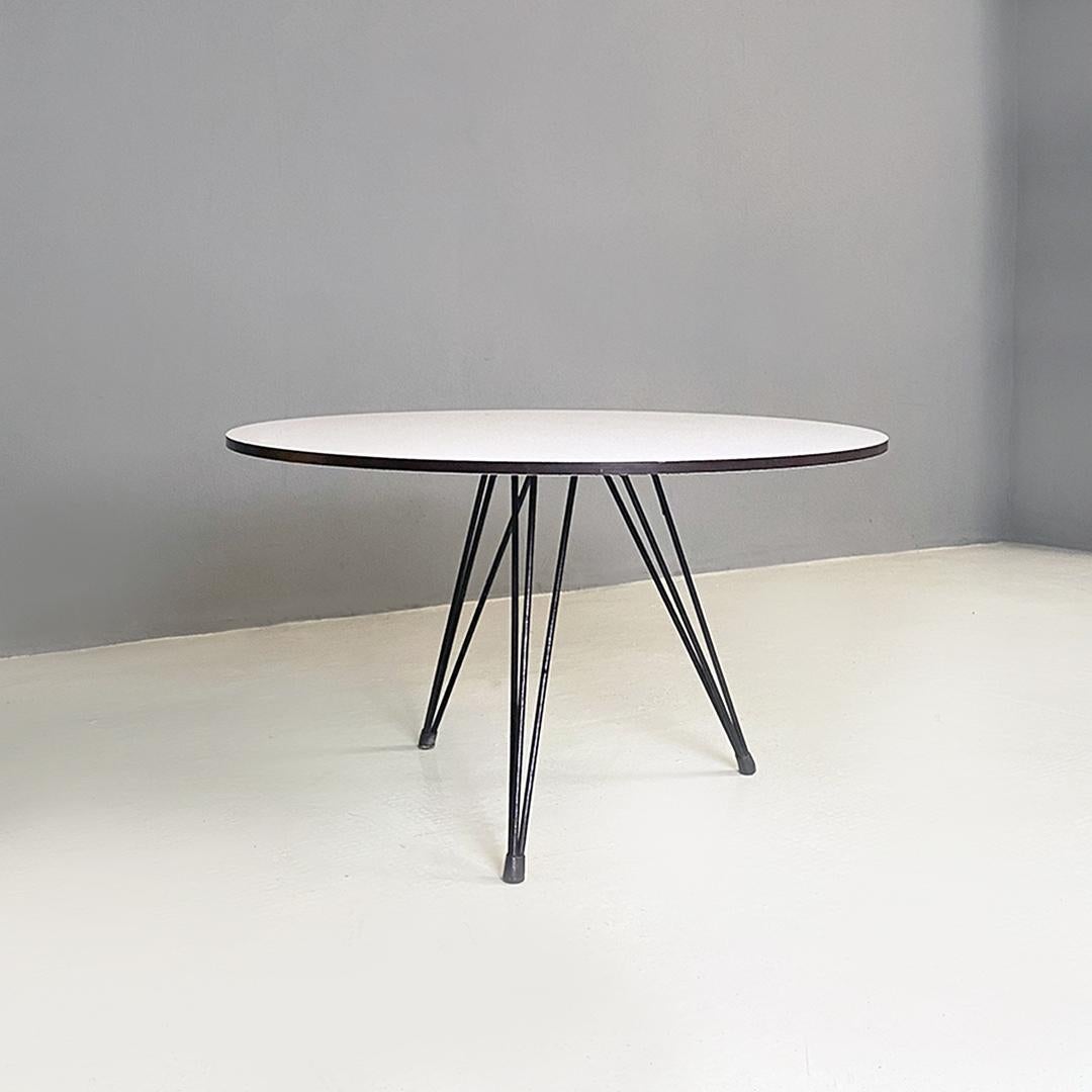 Scandinavian Mid-Century Modern round white laminate and black metal coffee table, 1960s
Coffee table from northern Europe with metal base, white laminate top with black edge, round shape.
Three-legged base with triple black metal rod and rubber