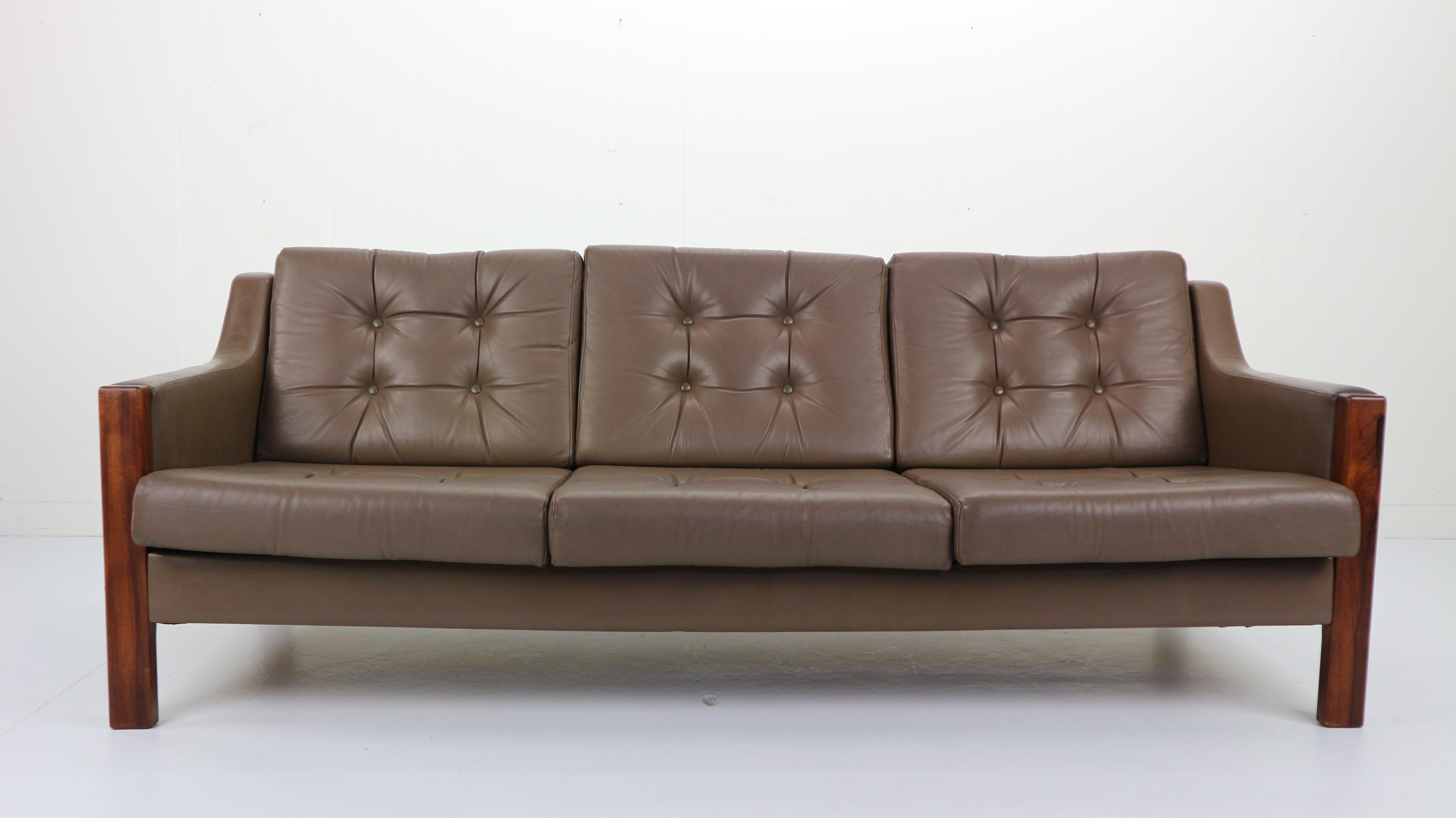Scandinavian design three-seat comfortable sofa made in late 1960s-early 1970s.
High quality leather seating and rosewood frame.
Good vintage condition. Patinated with signs of wear consistent with age and use.
In a style of Hans J. Wegner.
 