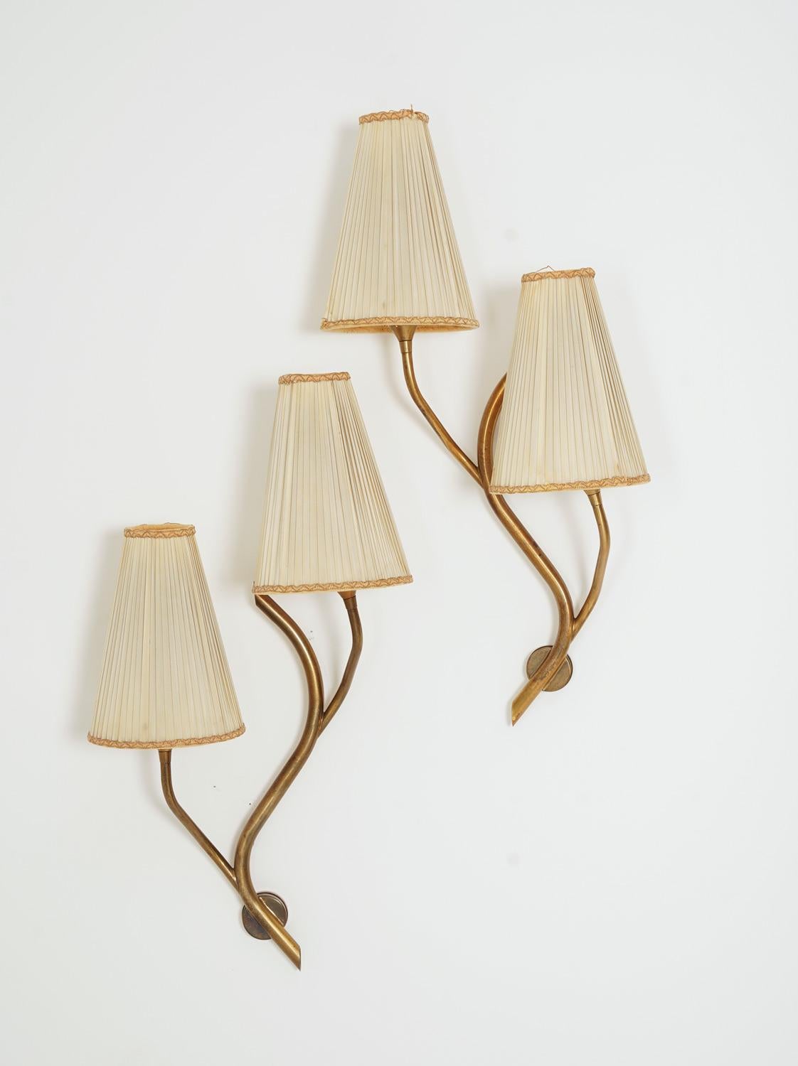 Pair of wall lamps produced by Astra, Norway, 1950s.
Stunning organically-shaped wall lamps, creating a perfect pair. The lamps come with vintage off-white fabric shades.

Condition: Good original condition with patina. The shades have som stains