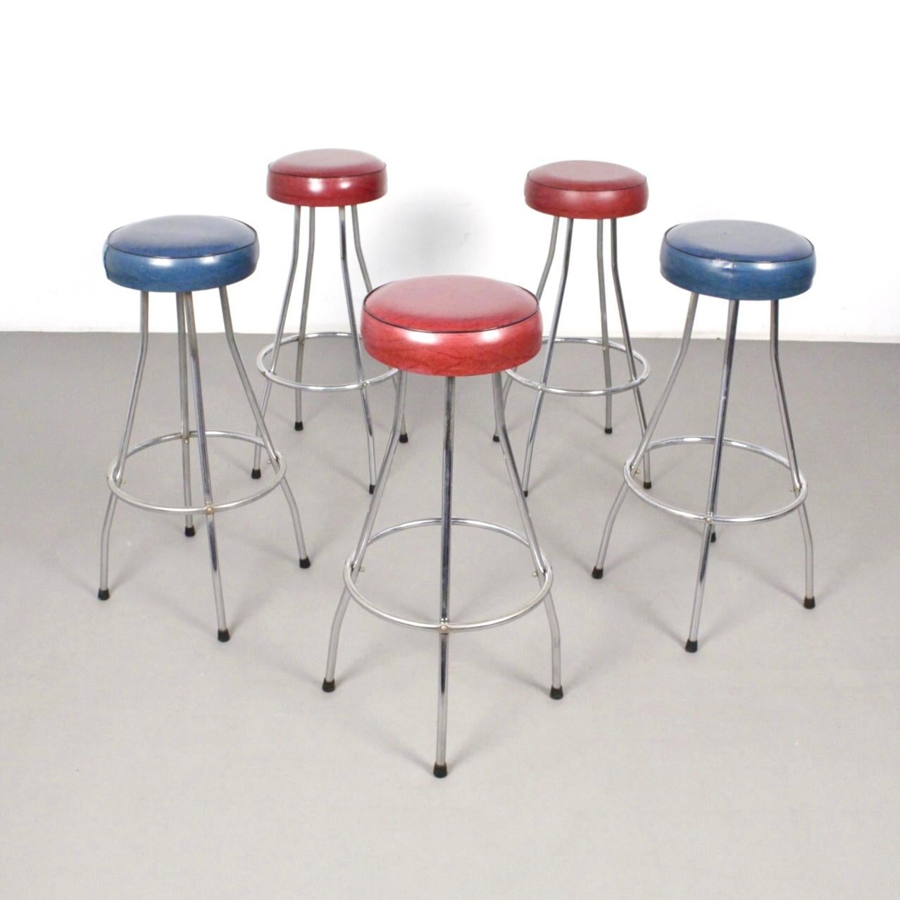 Scandinavian midcentury bar stools made in chromed tubular steel frame. Red (3) and blue (2) skai leather upholstered seats.