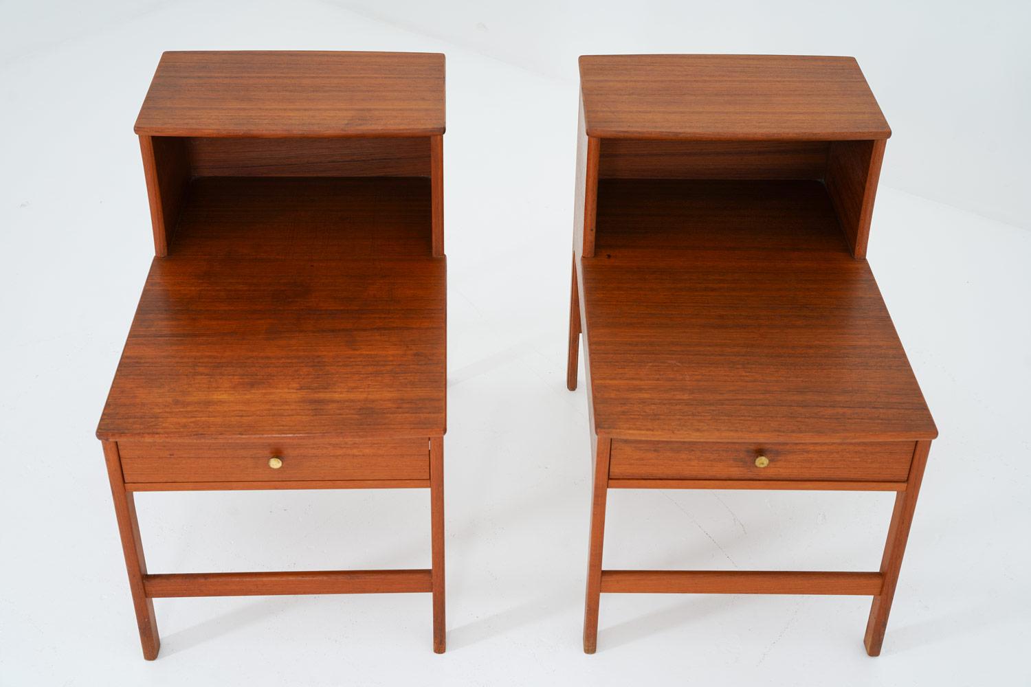 Rare bedside tables in teak by Yngvar Sandström for Seffle Möbelfabrik, Sweden. 
These bedside tables offer two tabletops on different levels with a drawer under the bottom table top. The generous proportions of the tables leave lots of space for